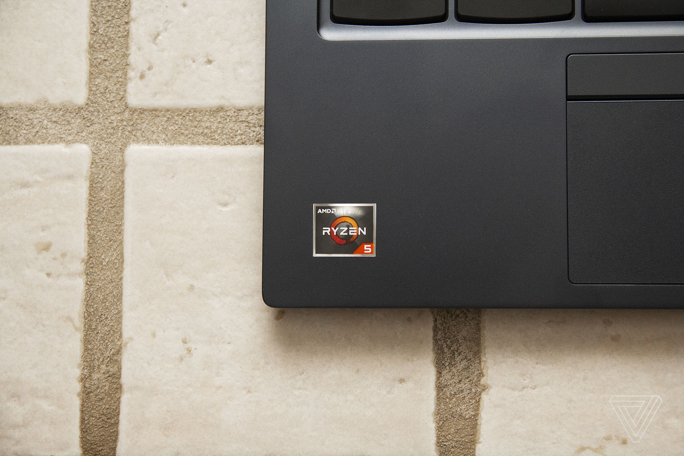The AMD Ryzen 5 sticker on the bottom left corner of the ThinkPad C13 Yoga Chromebook.