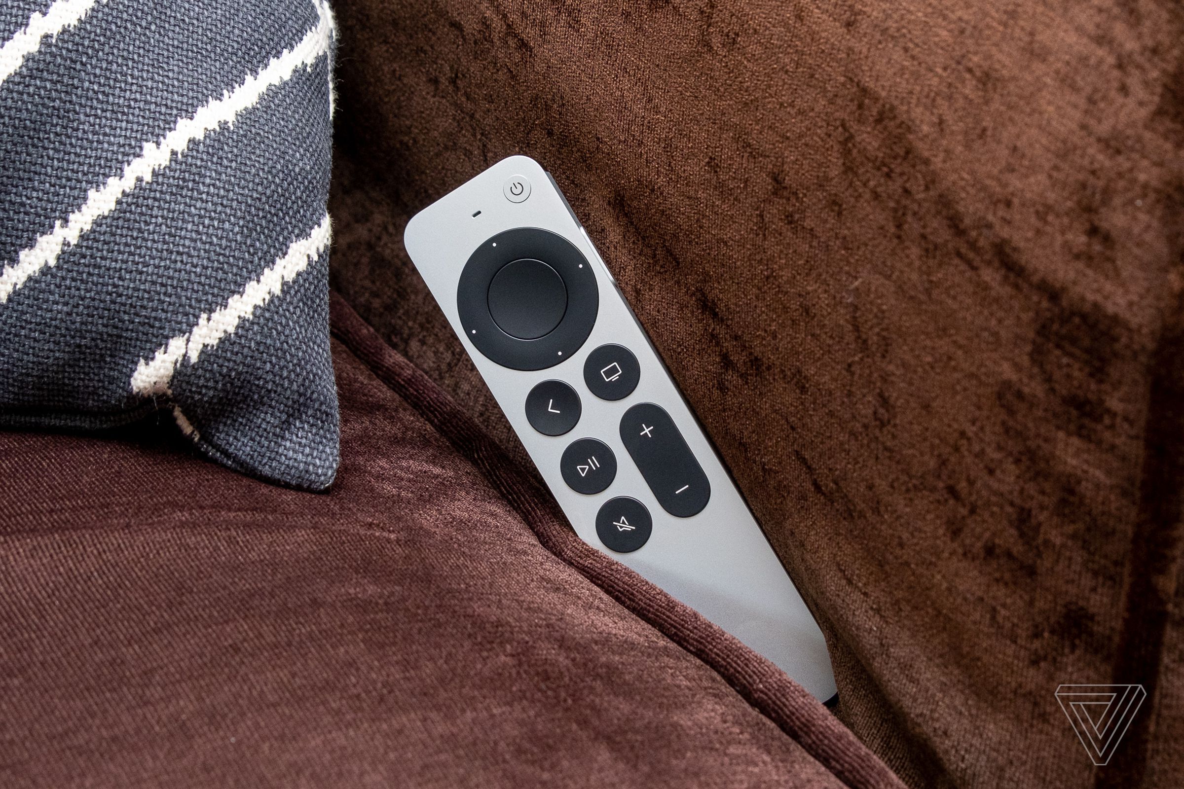 A photo of the Apple TV remote wedged into a couch.