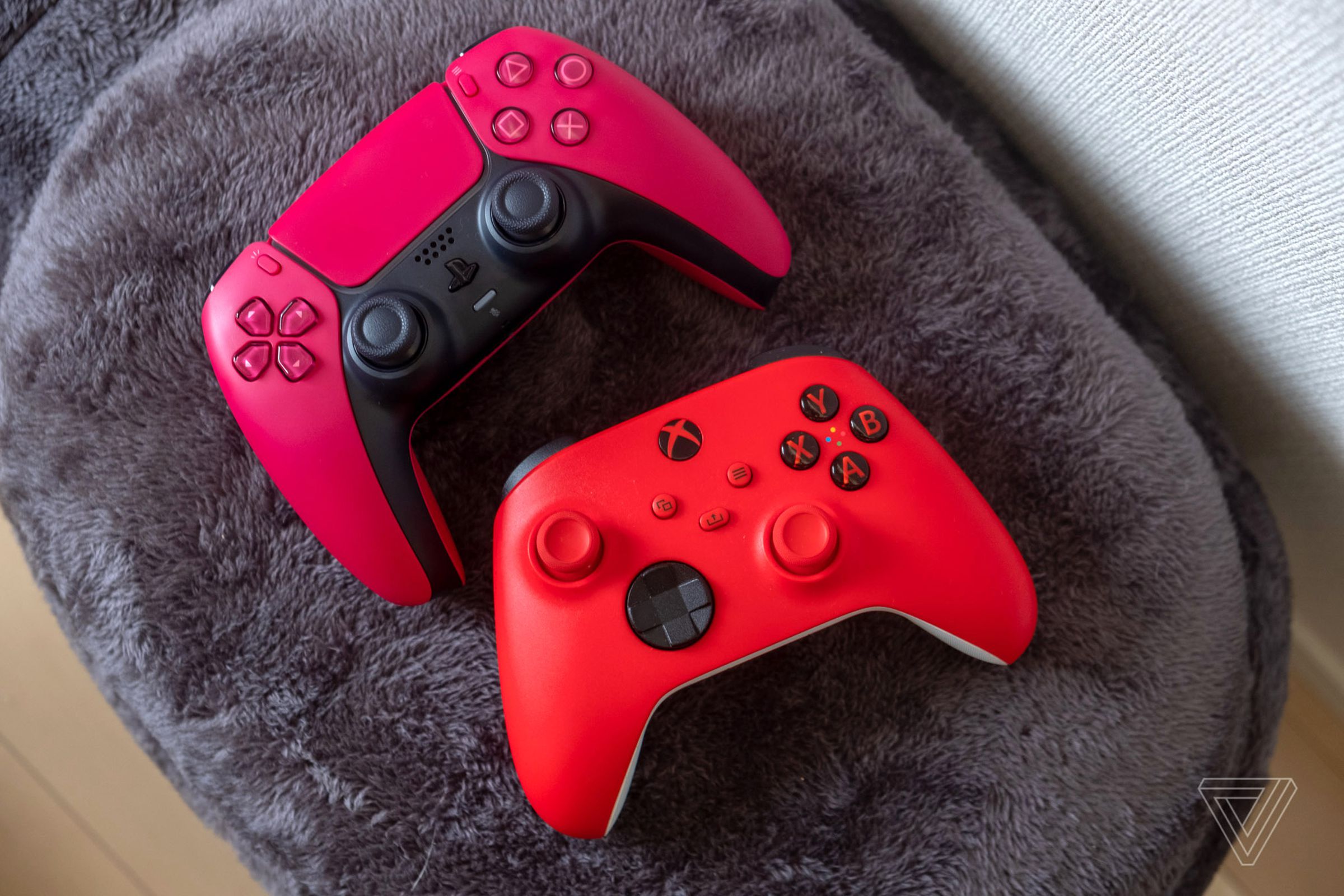 The red PS5 controller next to its Xbox Series equivalent.