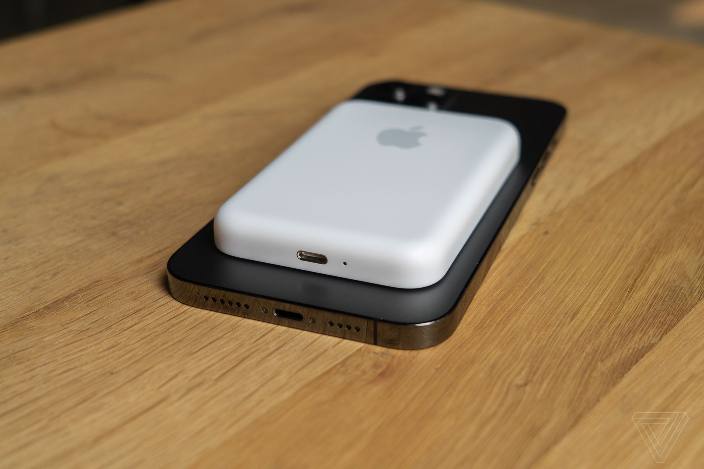 A MagSafe Battery Pack on the back of an iPhone.