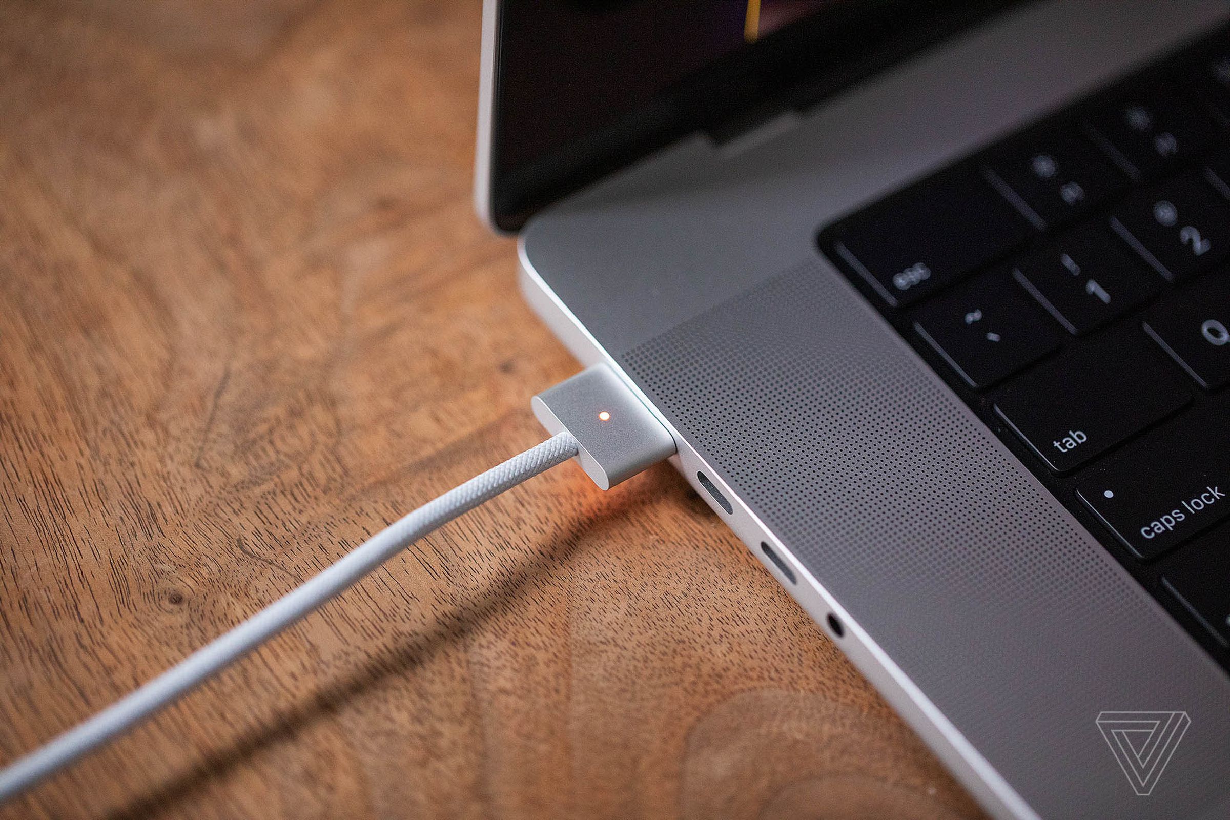 The new MagSafe 3 cable plugged in to the new MacBook Pro 16.
