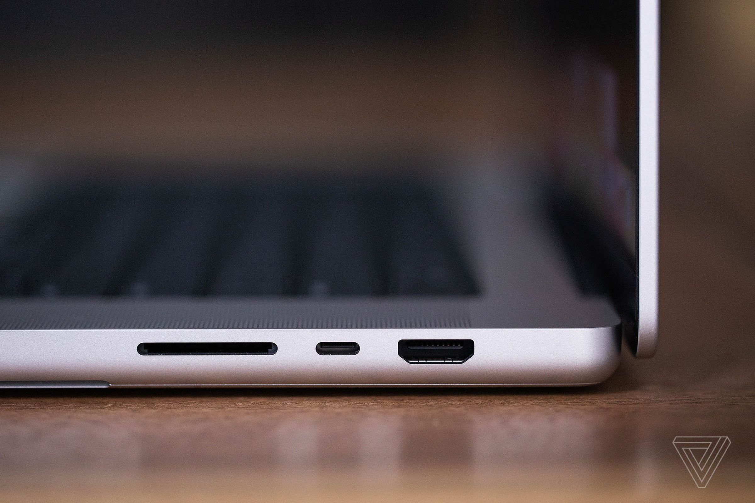 A side profile of the MacBook Pro 16 showing its full-size SD card slot, Thunderbolt 4 USB-C port, and HDMI port.