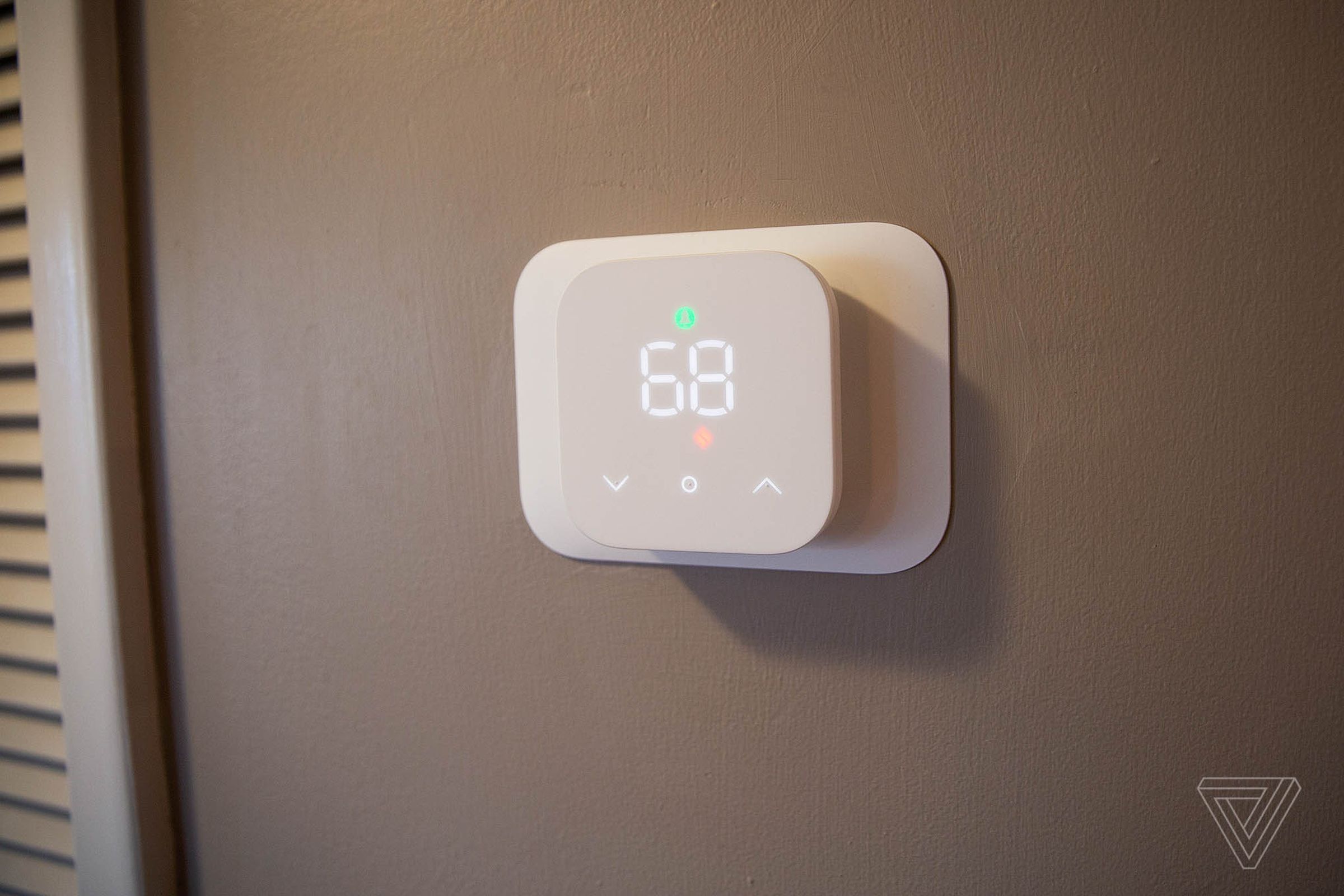 The Amazon Smart Thermostat mounted to a wall.
