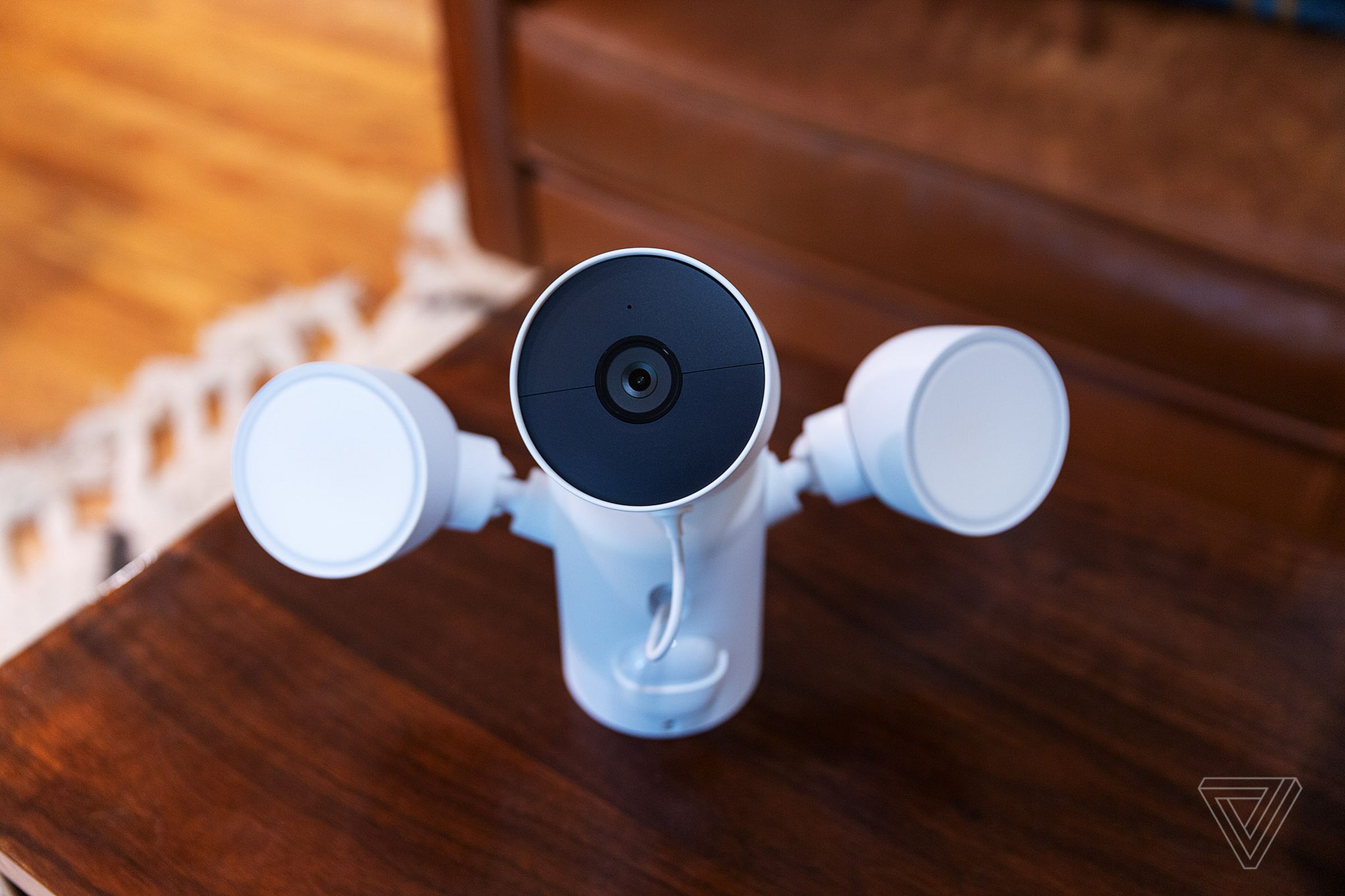 The Google Nest Cam with floodlight sitting on a table before installation.