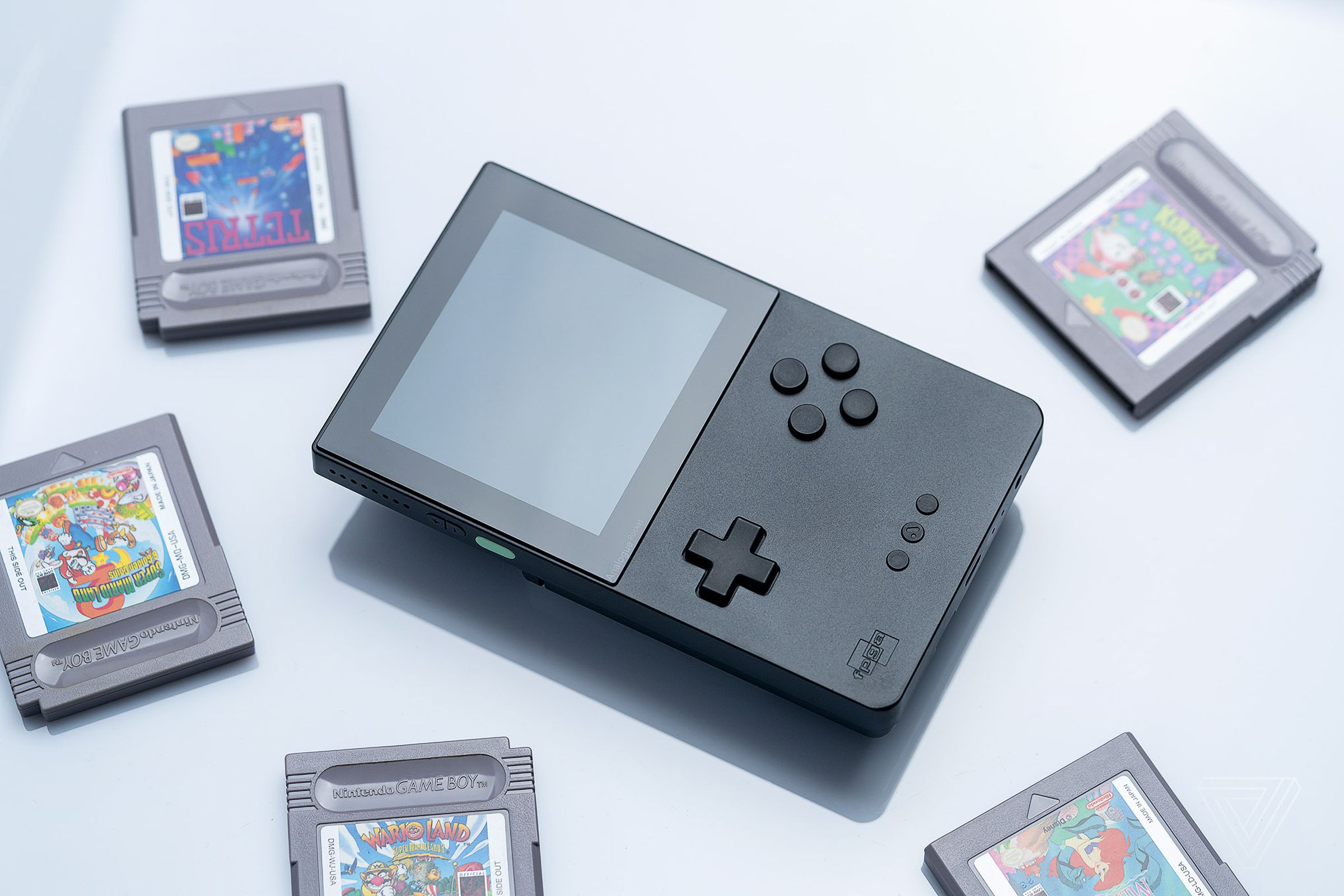 An Analogue Pocket surrounded by game cartridges