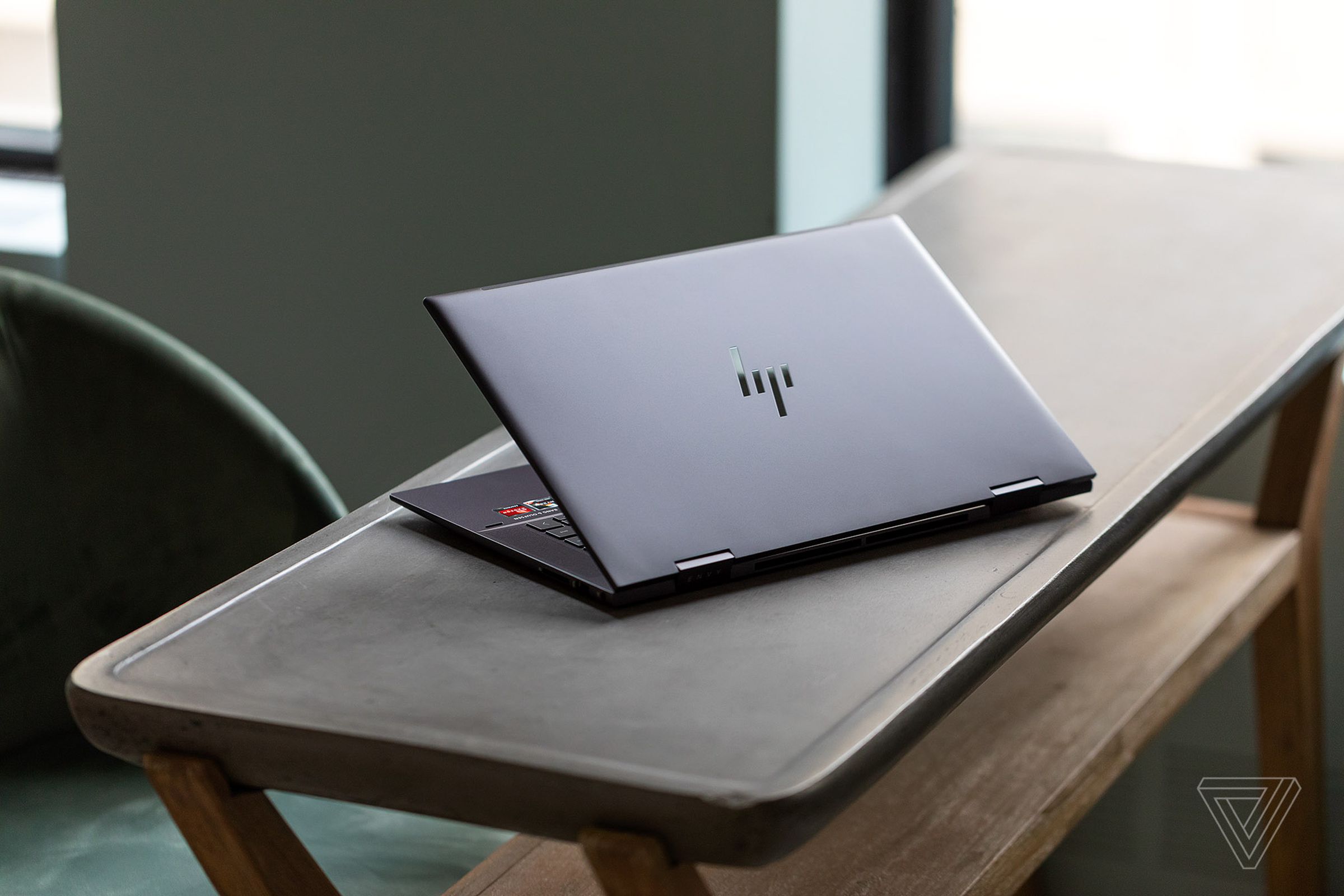 The HP Envy x360 15 half open on a table.