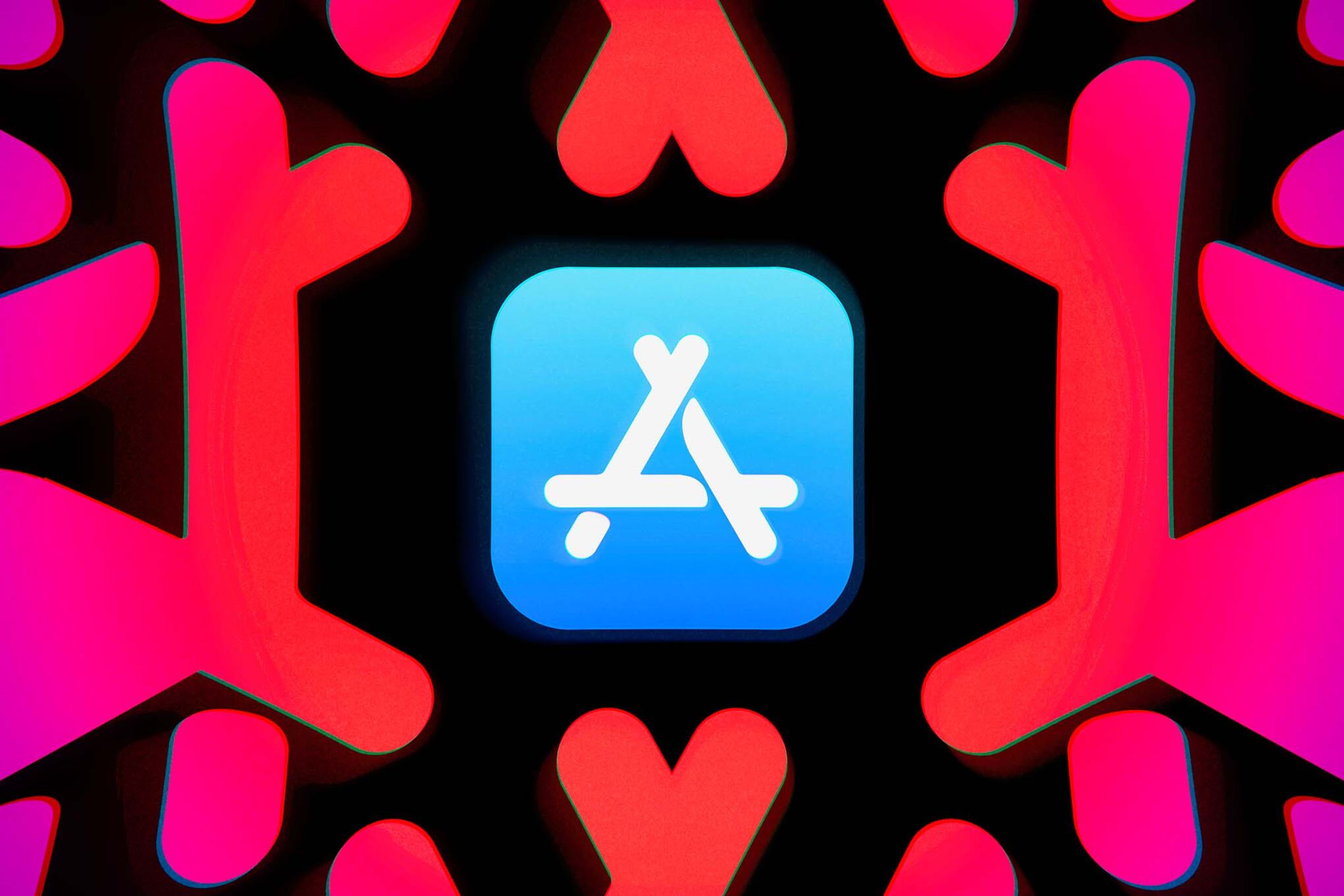 A picture of the App Store logo with larger, red versions of the App Store “A” surrounding it on a black background.