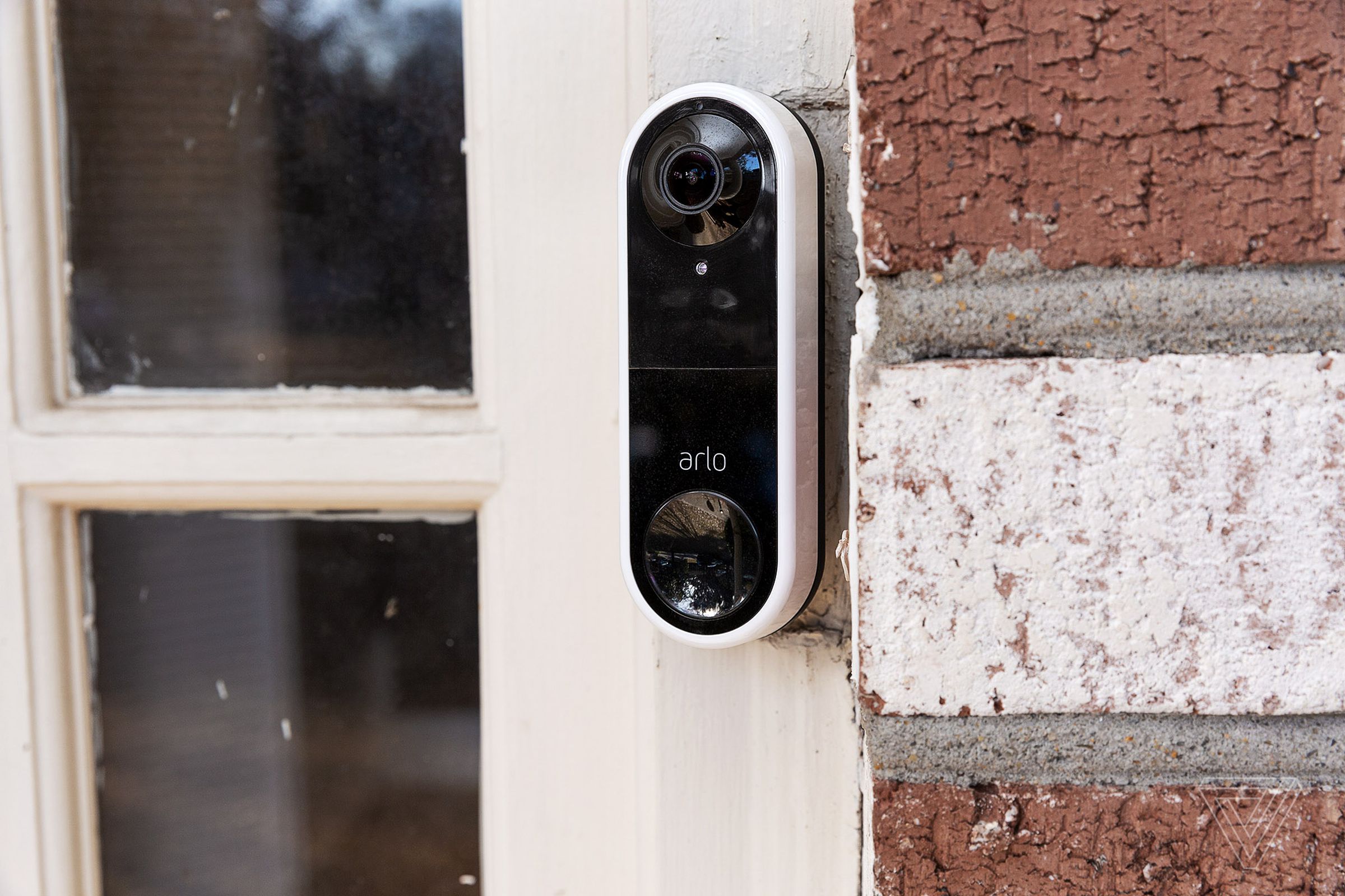 Arlo’s Essential wired video doorbell installed on a front door.
