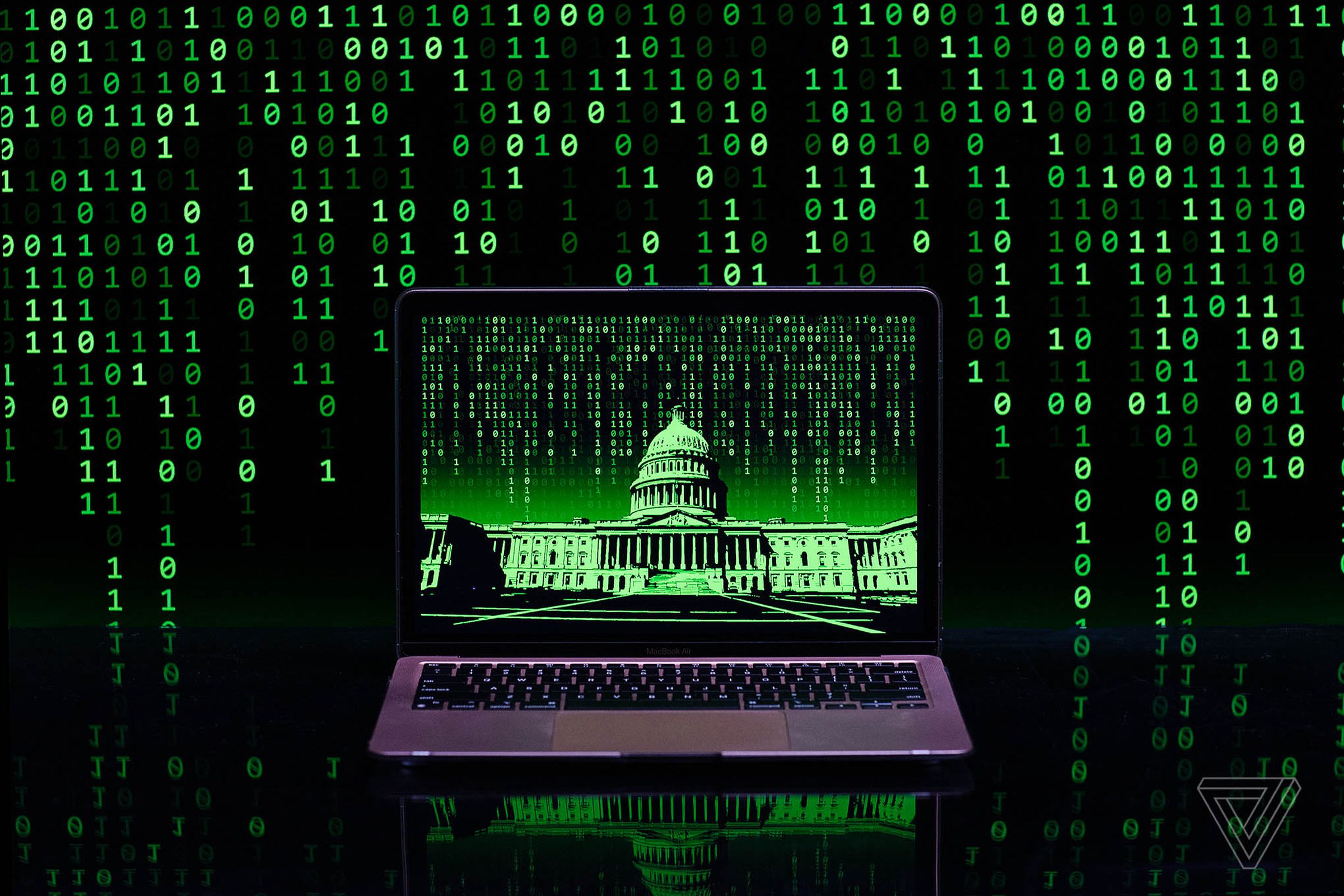 Digital photo illustration of a laptop displaying a black and green image of the Capitol building, with ones and zeroes falling in the background.