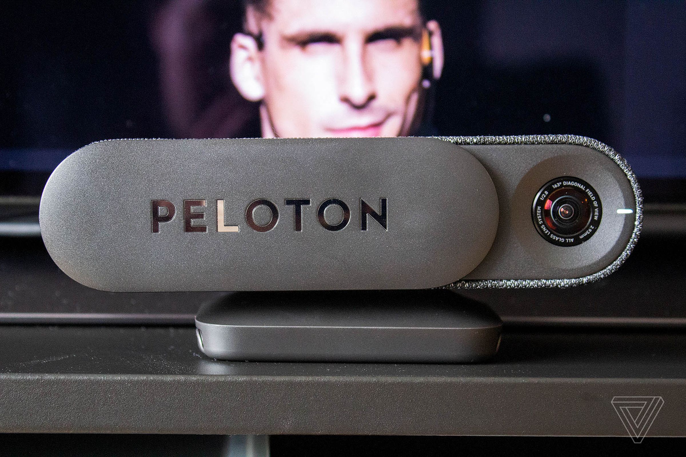The Peloton Guide with the camera open in front of a TV