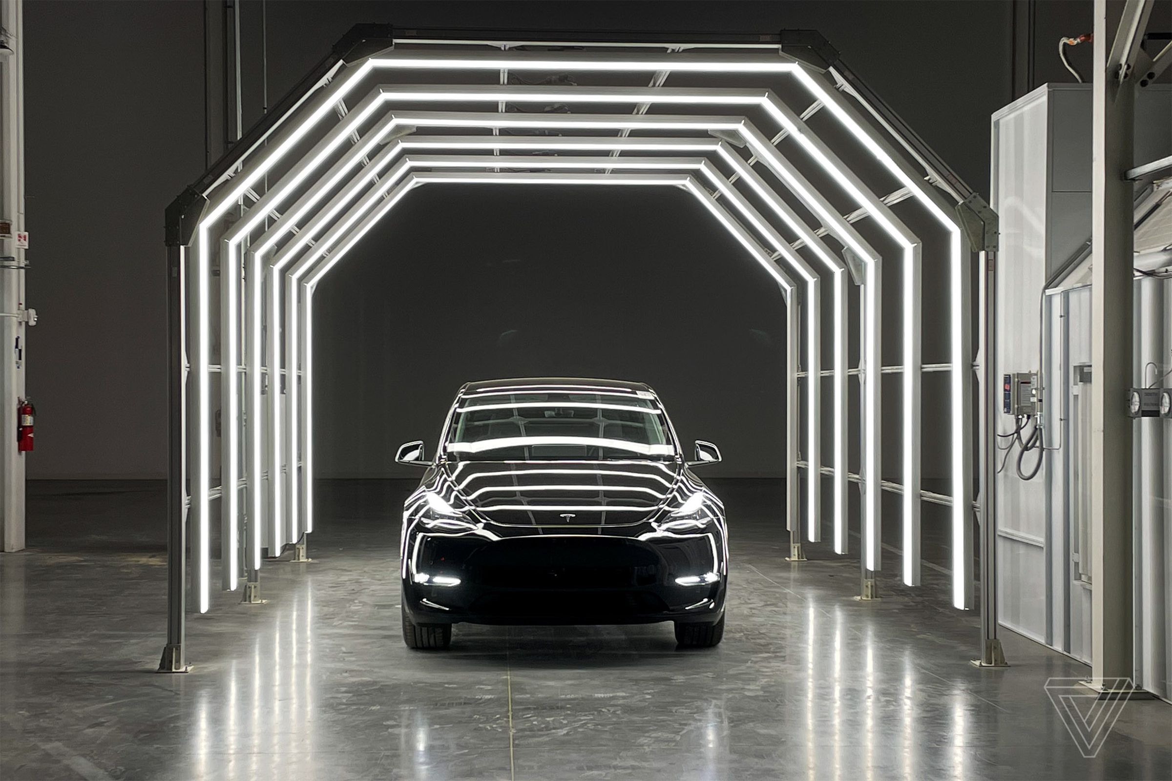 A Tesla vehicle in a lighted tunnel.