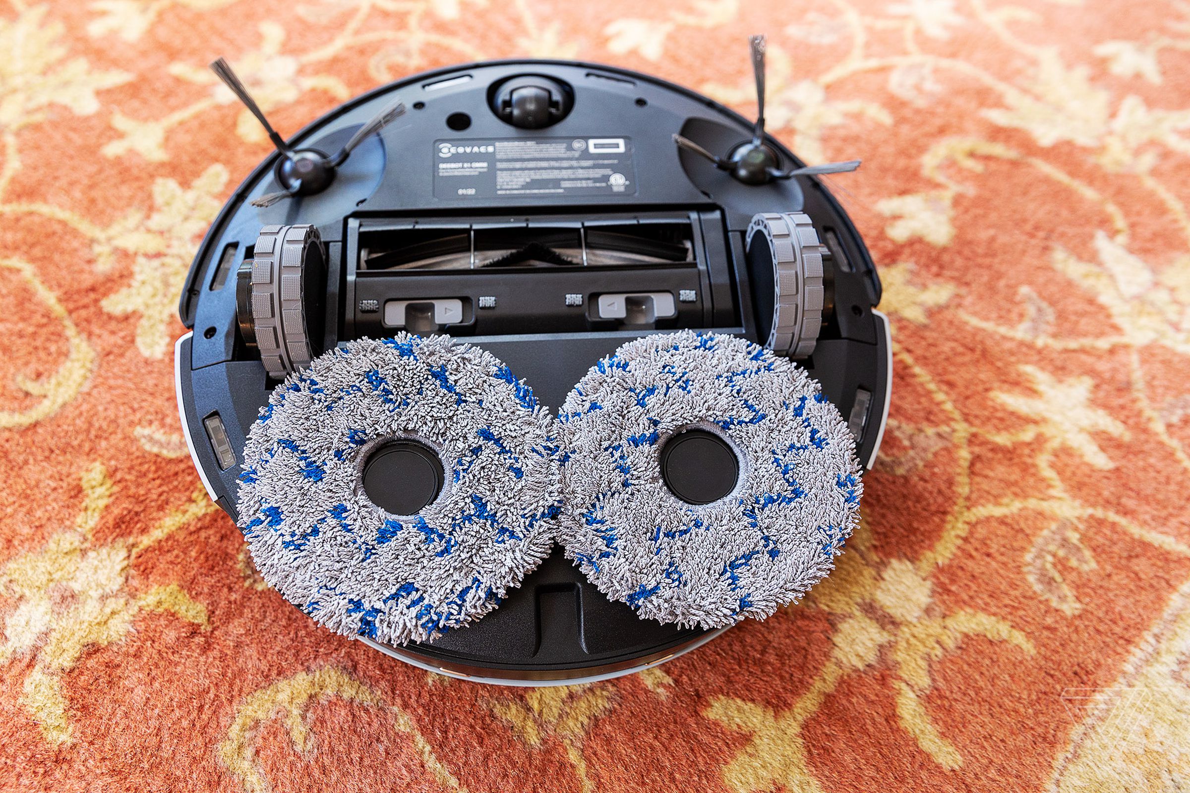Underneath the Deebot X1 Omni are two rotating brushes and two removable mop pads.  I can't help but see a face with an anxious expression asking 