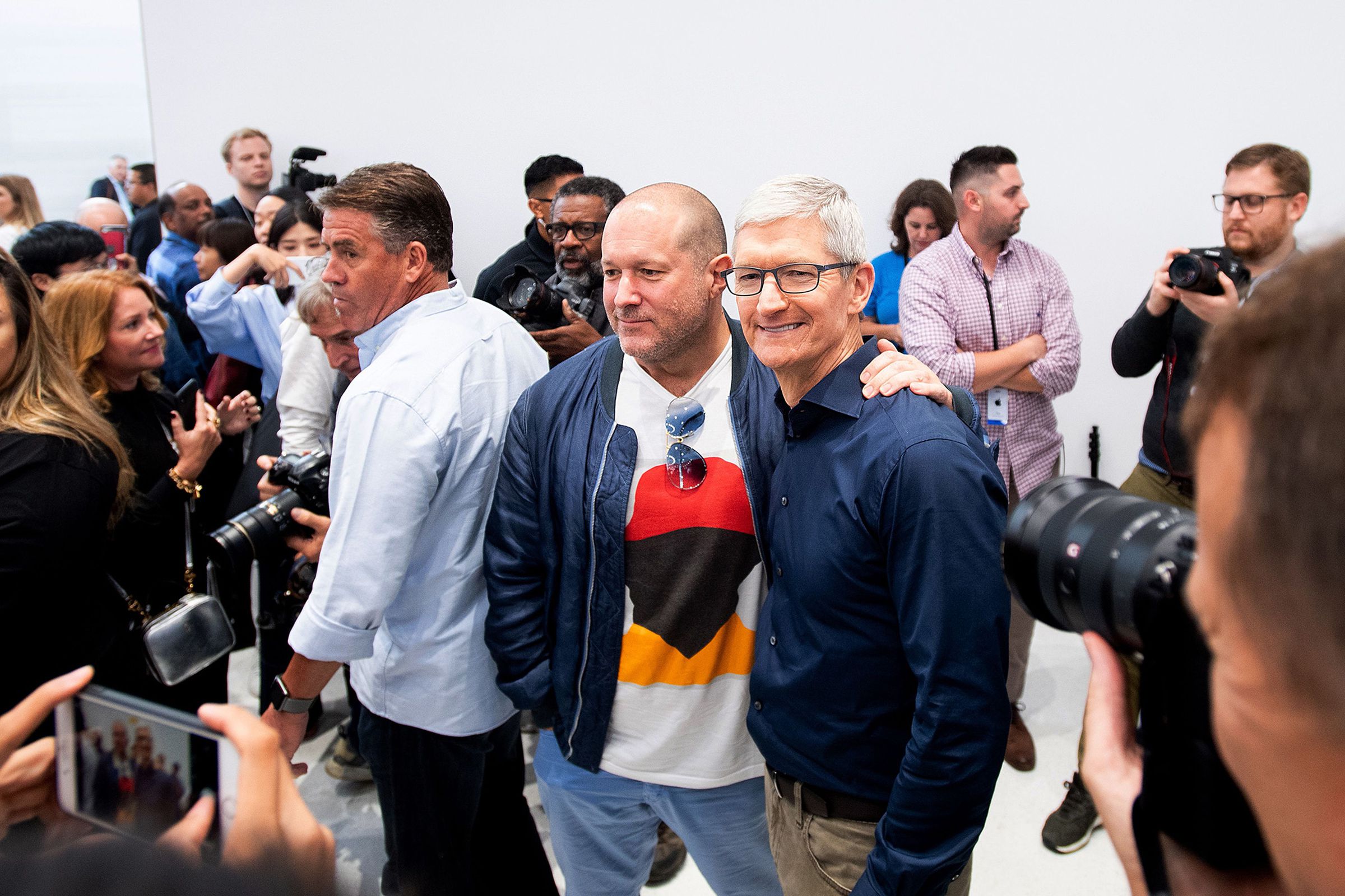 Apple Chief Design Officer Jonathan Ive (L) poses for pictures with CEO Tim Cook during a launch event on September 12, 2018, in Cupertino, California
