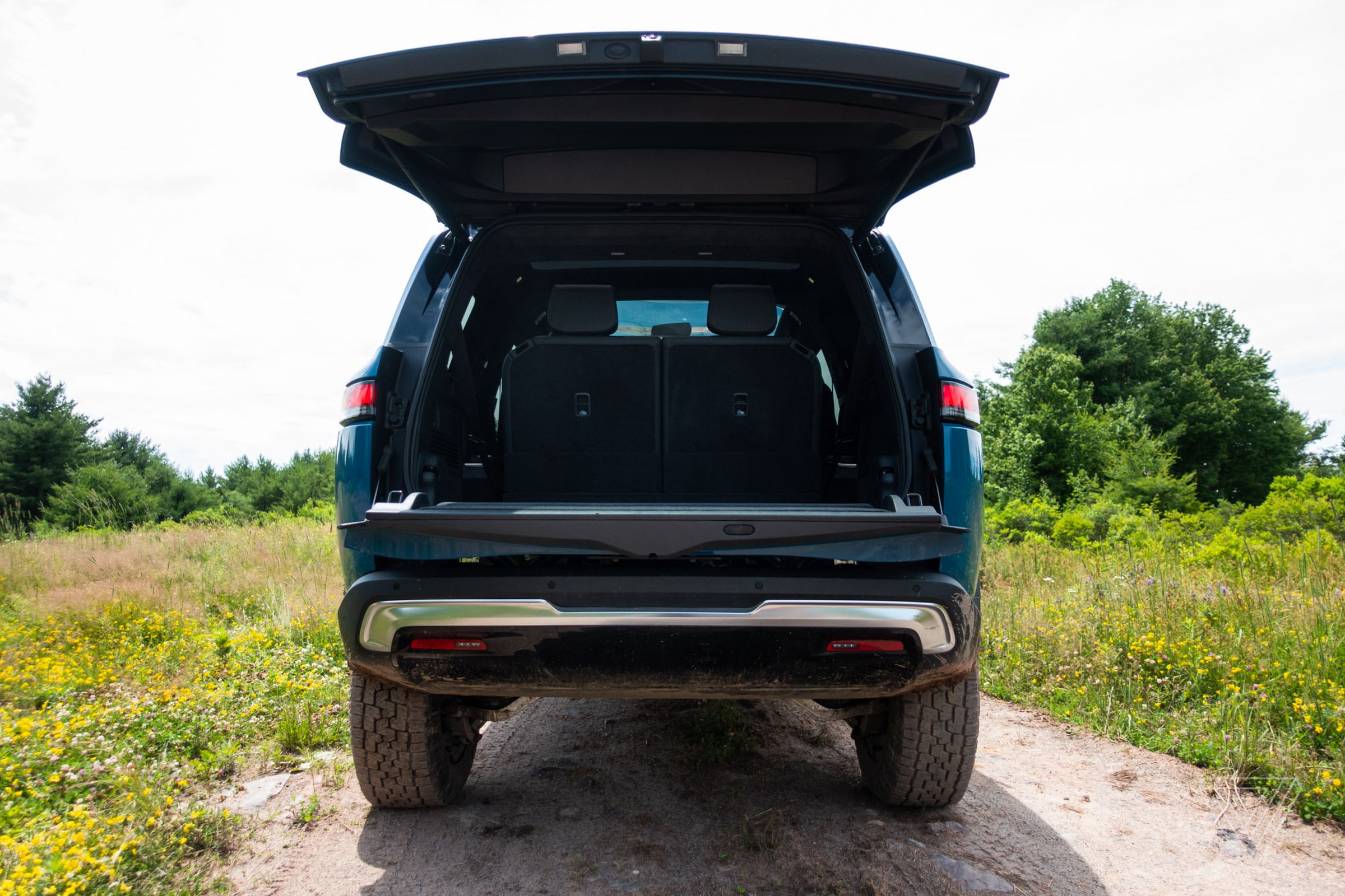 A Rivian R1S from the rear with the liftgate open