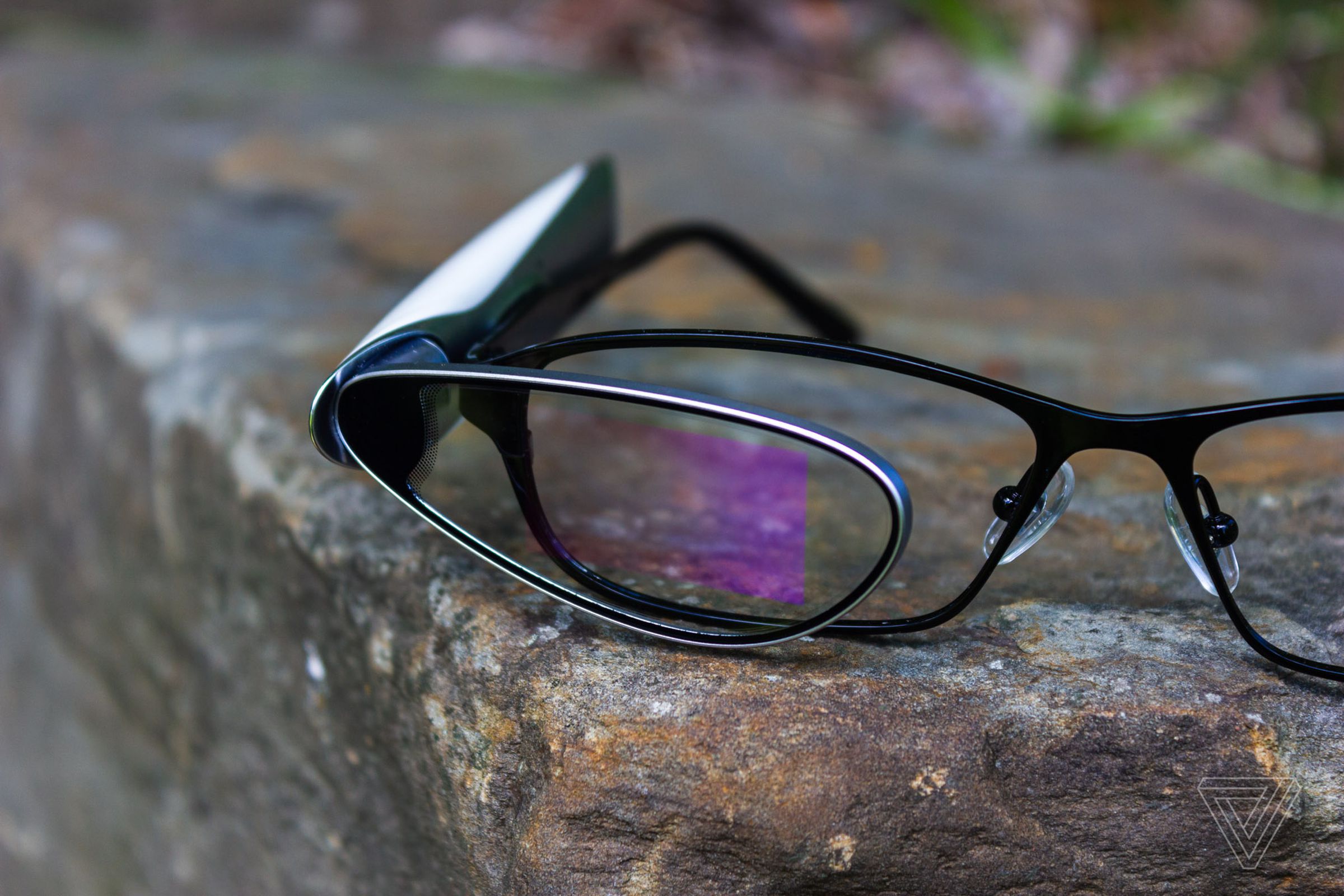 A pair of AR glasses with a holographic square in the middle.
