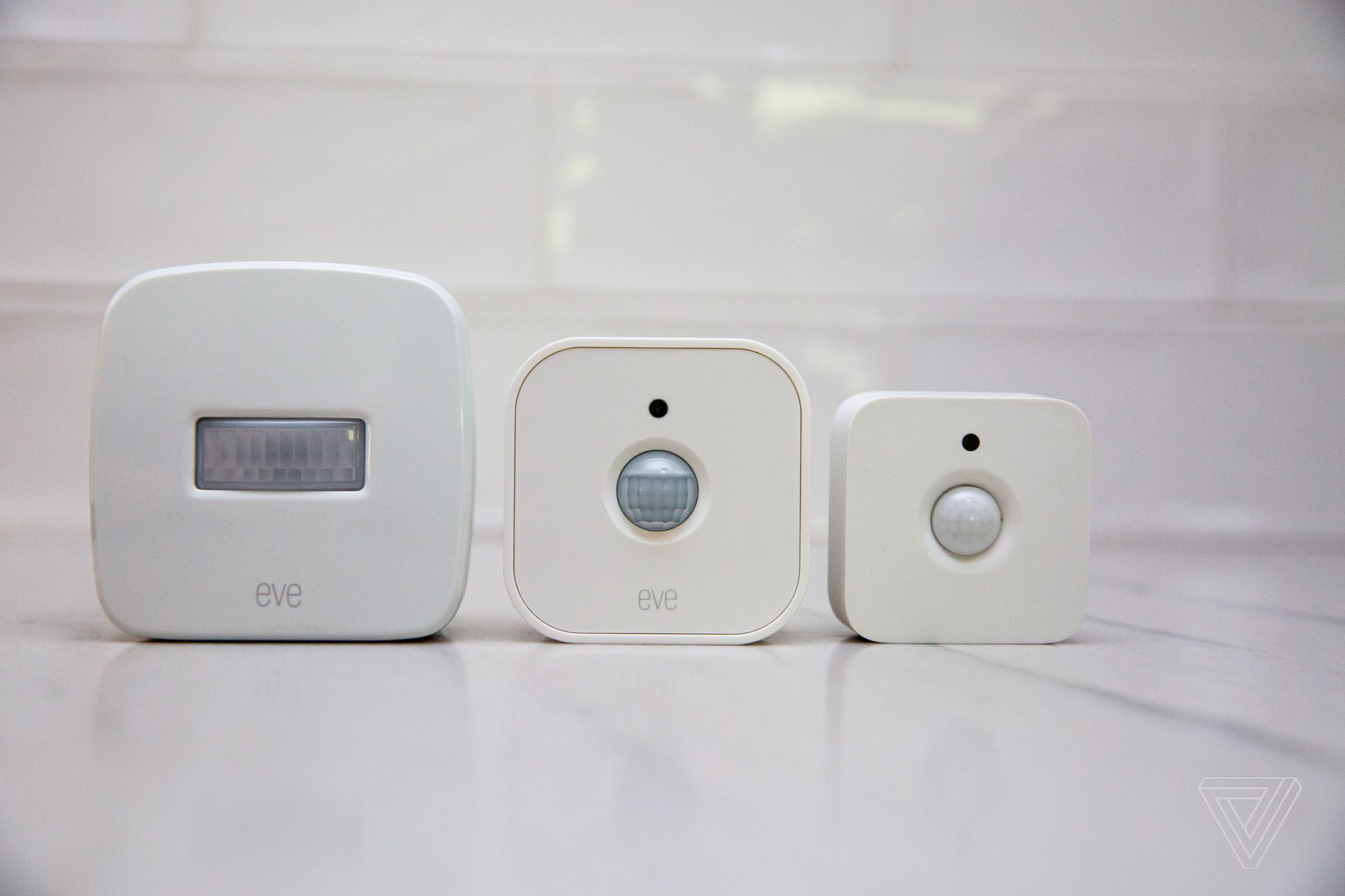 From left: the original Eve Motion sensor; the second-gen Eve; and the similar-looking Philips Hue Motion Sensor.