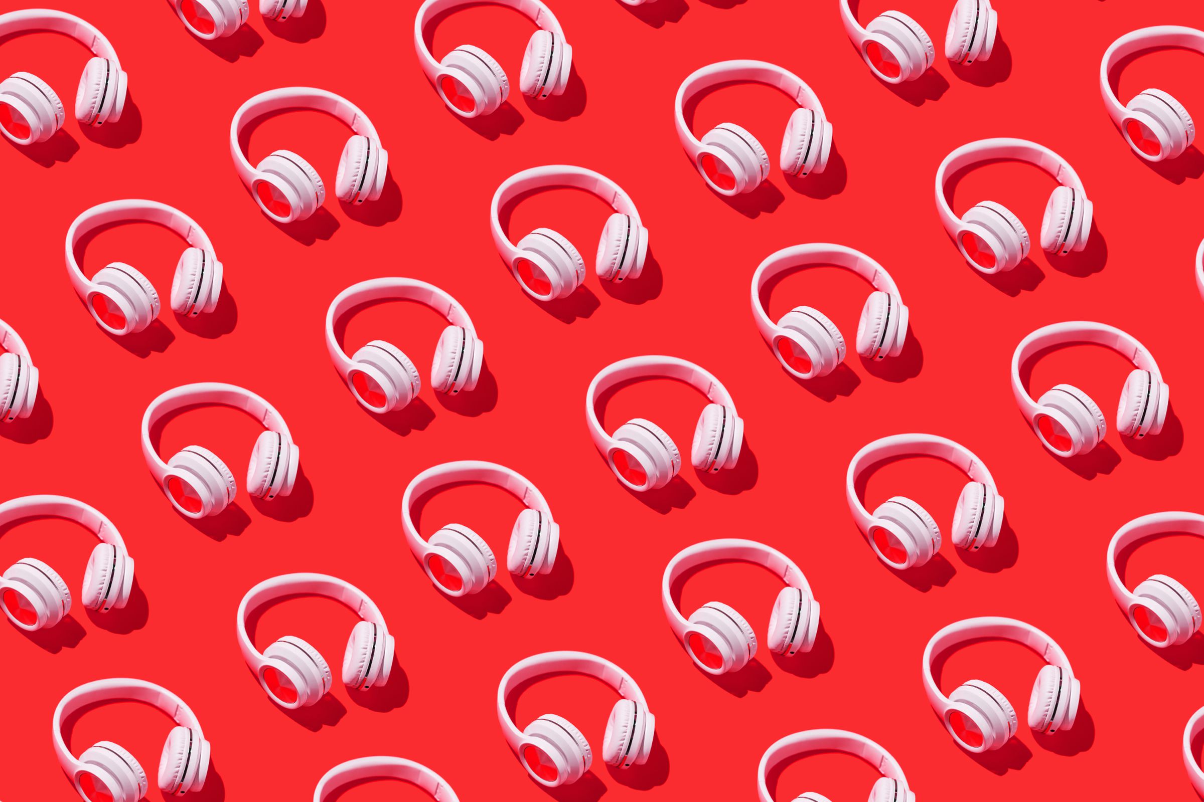 Red background with a repeating pattern of white headphones.