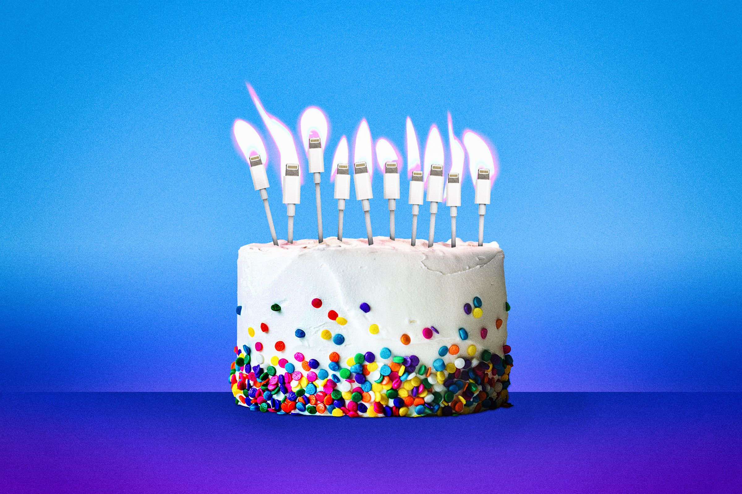 A birthday cake with 10 lit candles, which are actually Lightning connectors