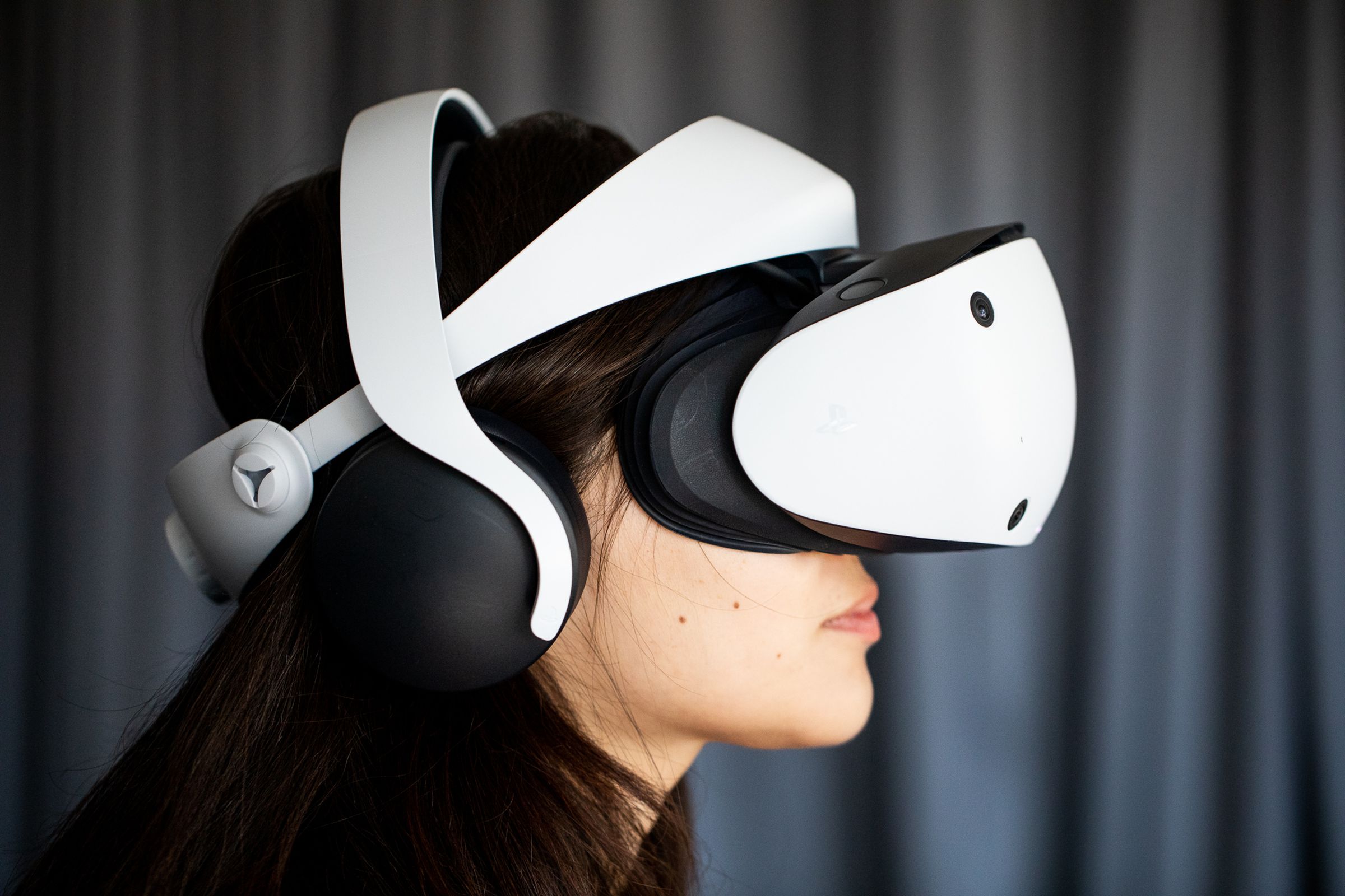 Verge reporter Victoria Song wearing the PlayStation VR2 virtual reality headset.