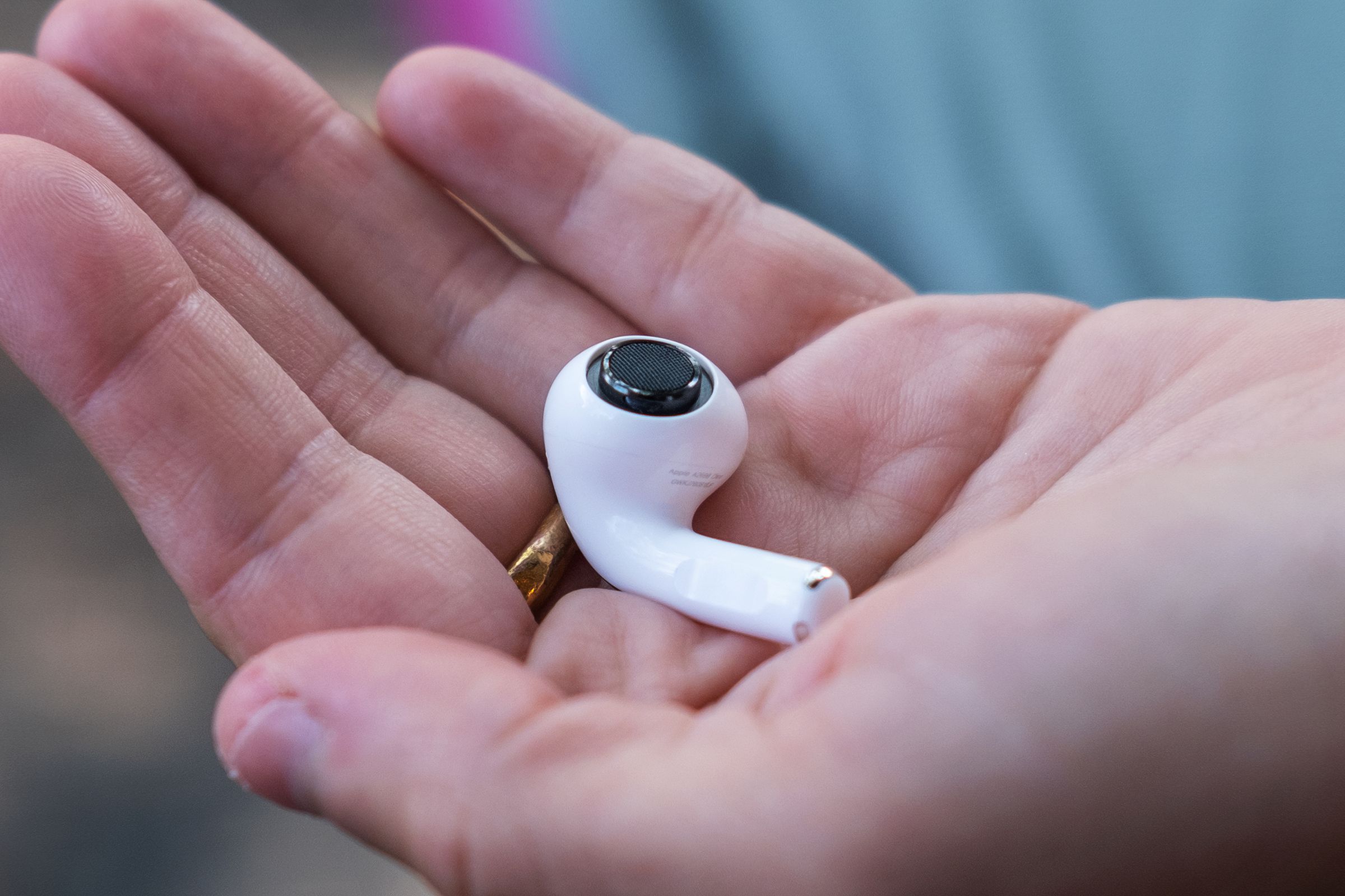 One of Apple’s second-generation AirPods Pro pictured in a person’s hand with the ear tip detached.