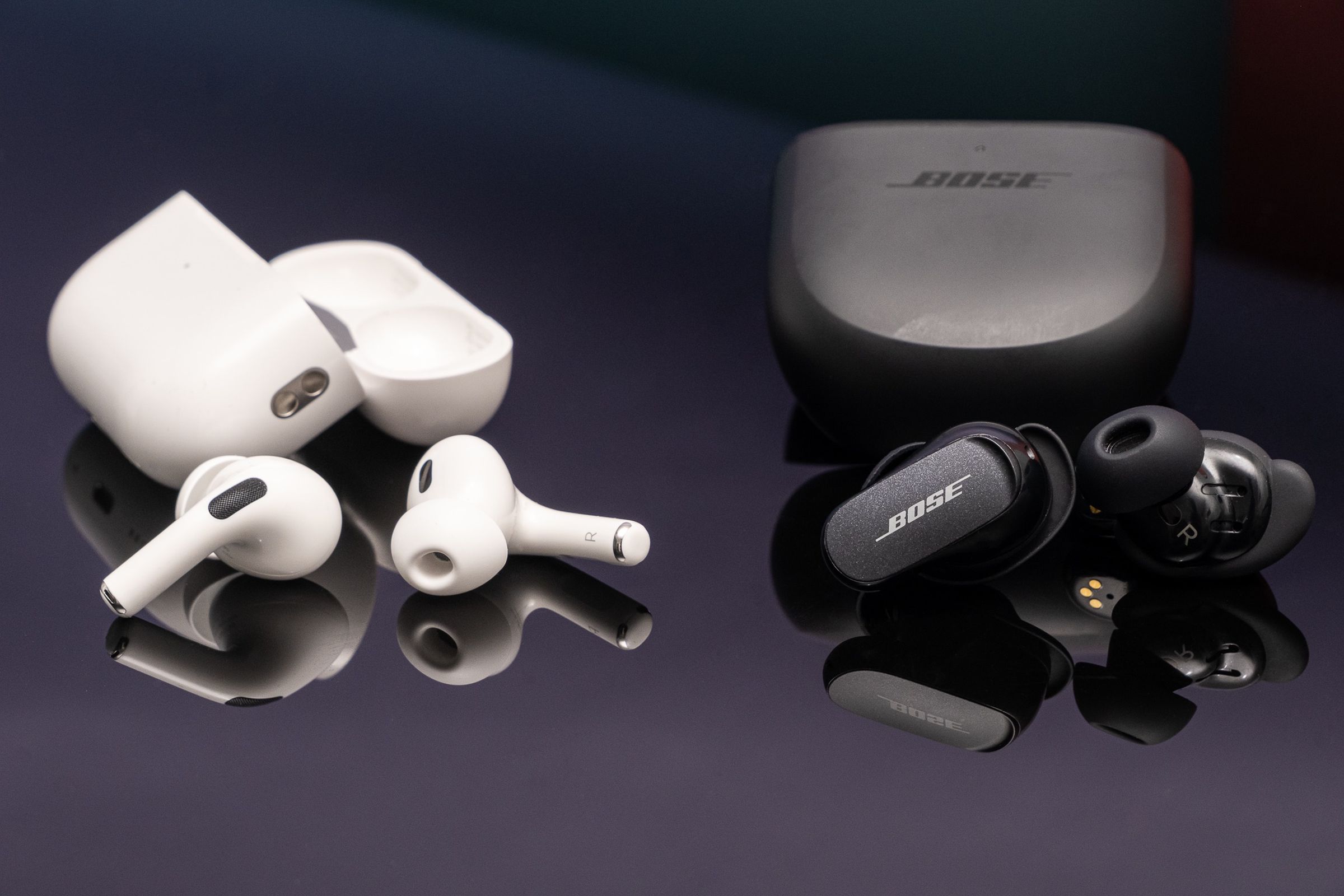 Apple’s second-generation AirPods Pro pictured next to Bose’s QuietComfort Earbuds II.