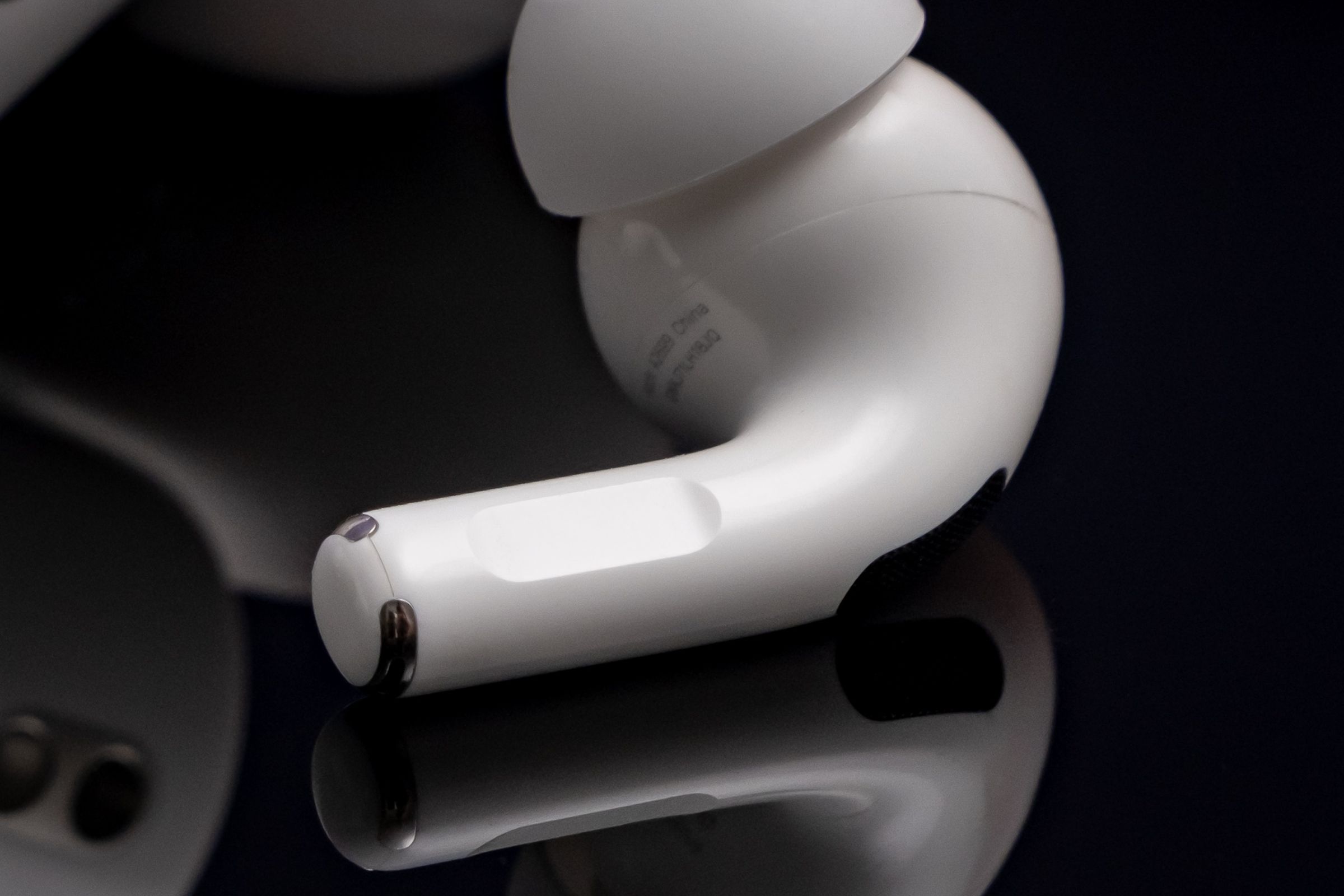 A close-up detail image of the touch sensor on Apple’s second-generation AirPods Pro.
