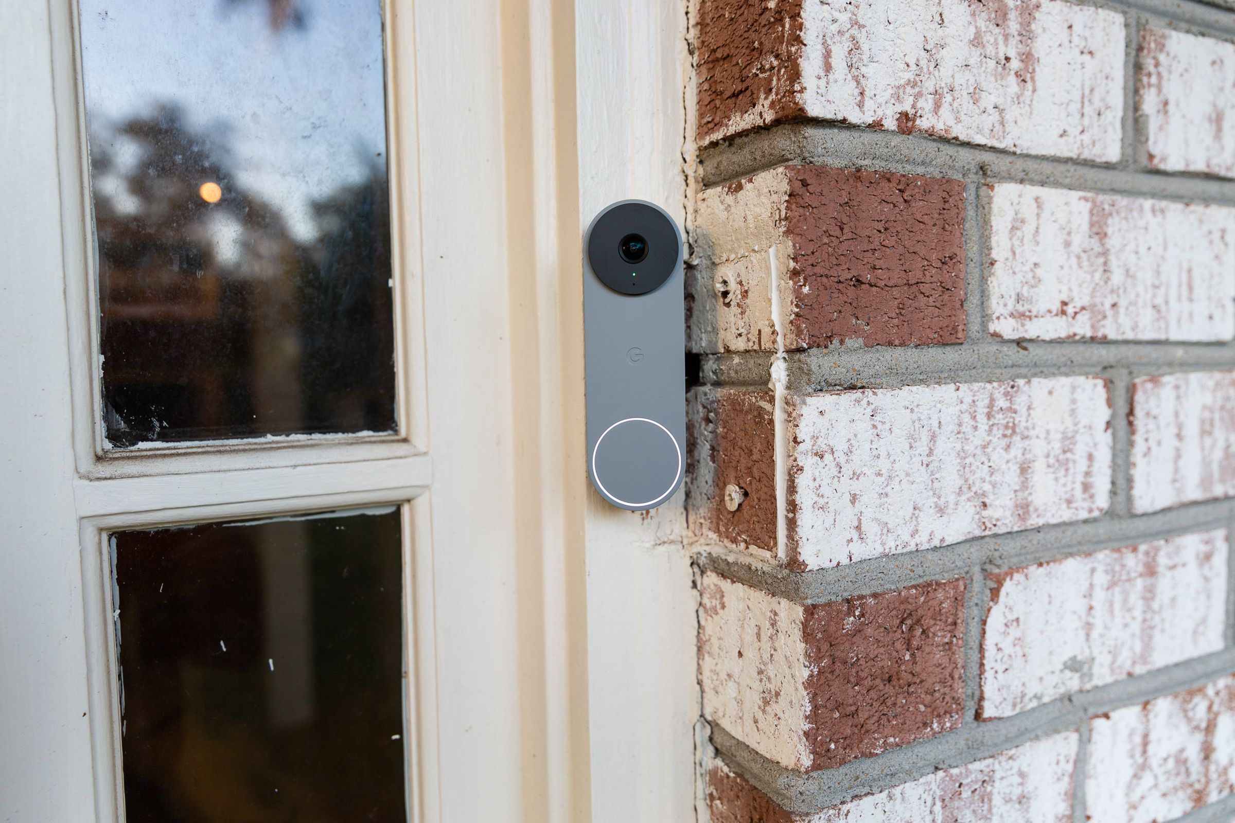 Google Nest smart doorbell attached to the side of a door.