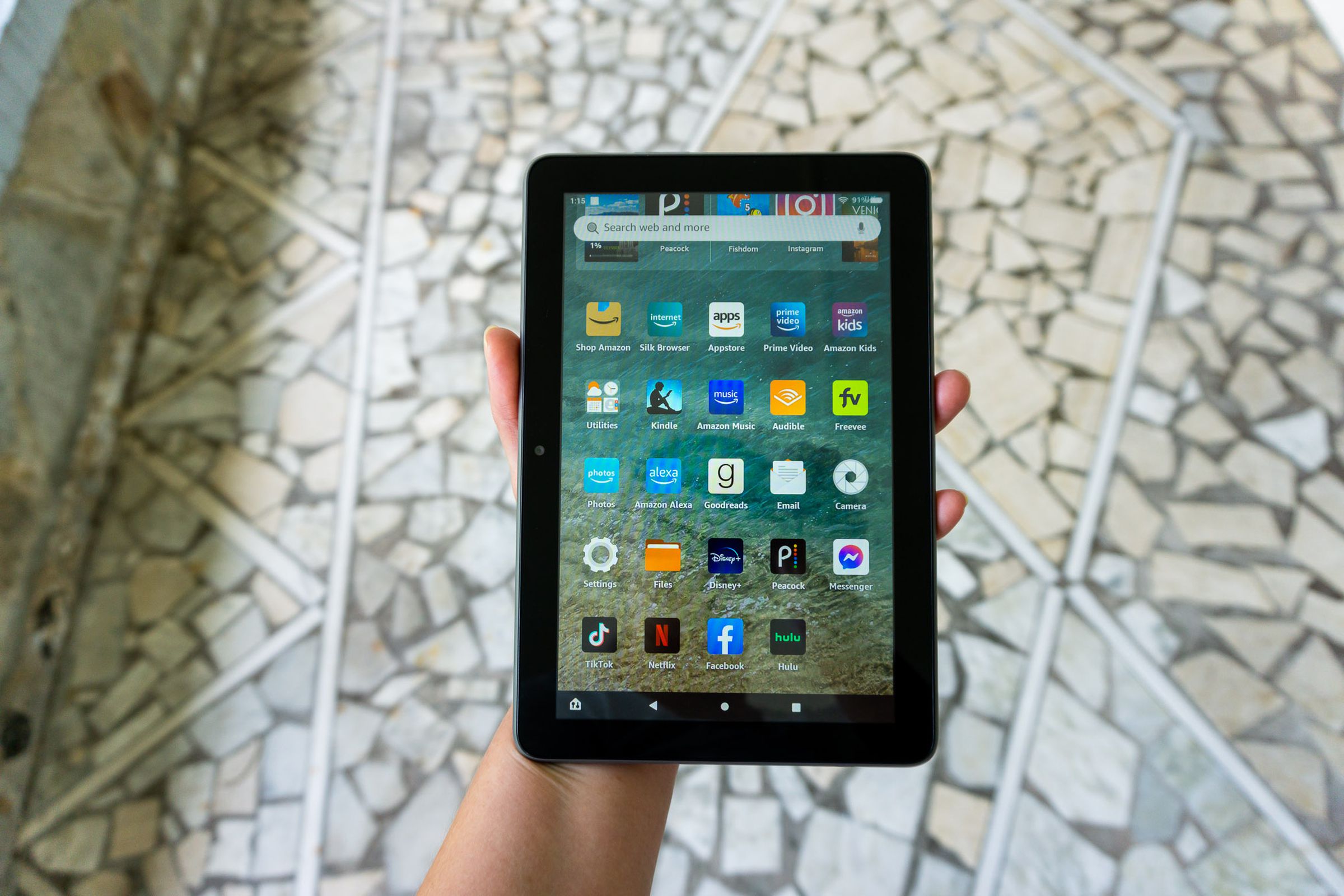A person holding the Amazon Fire HD 8 Plus tablet