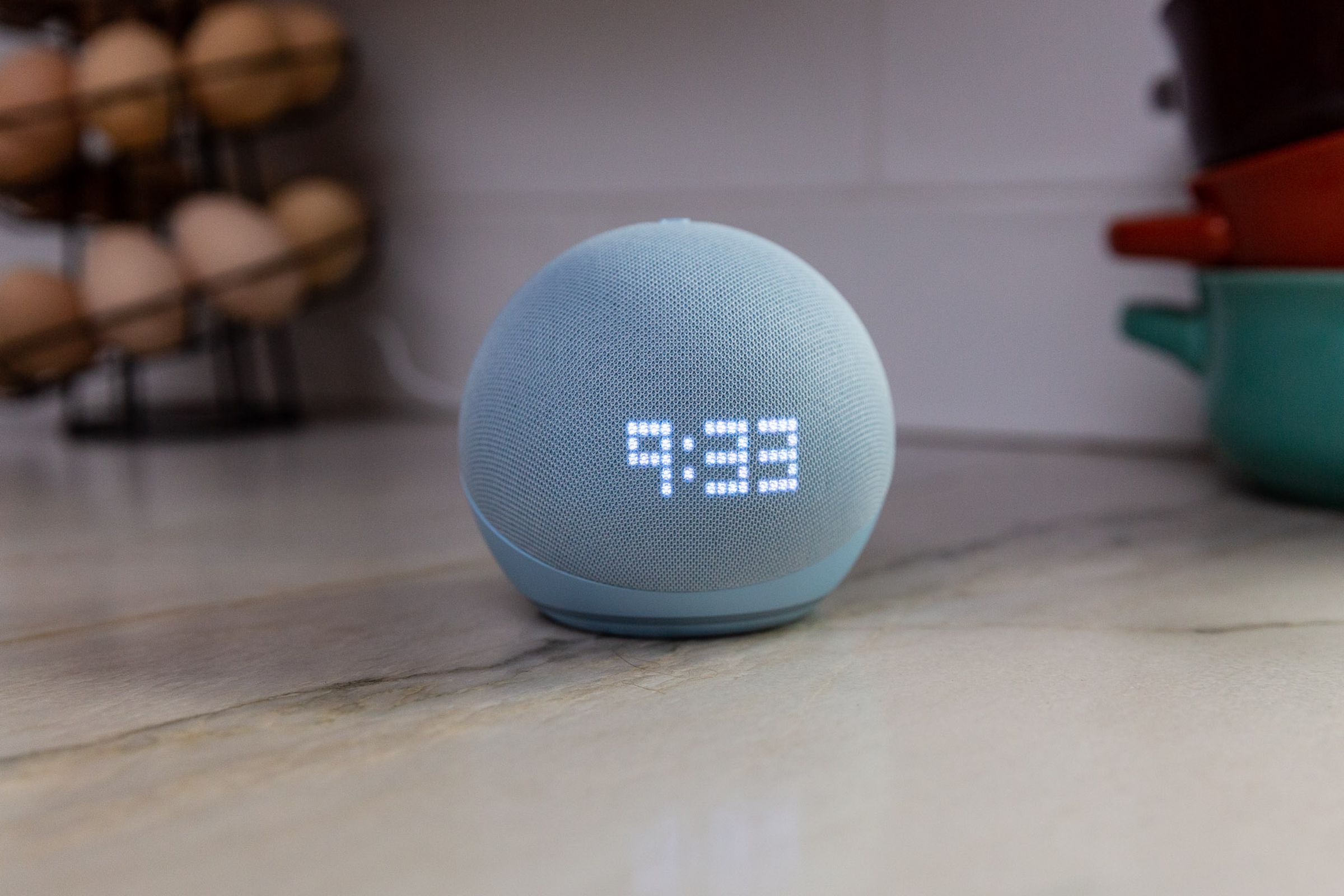 Amazon’s latest smart speaker, the fifth-gen Echo Dot with Clock, sitting on a table showing the time.