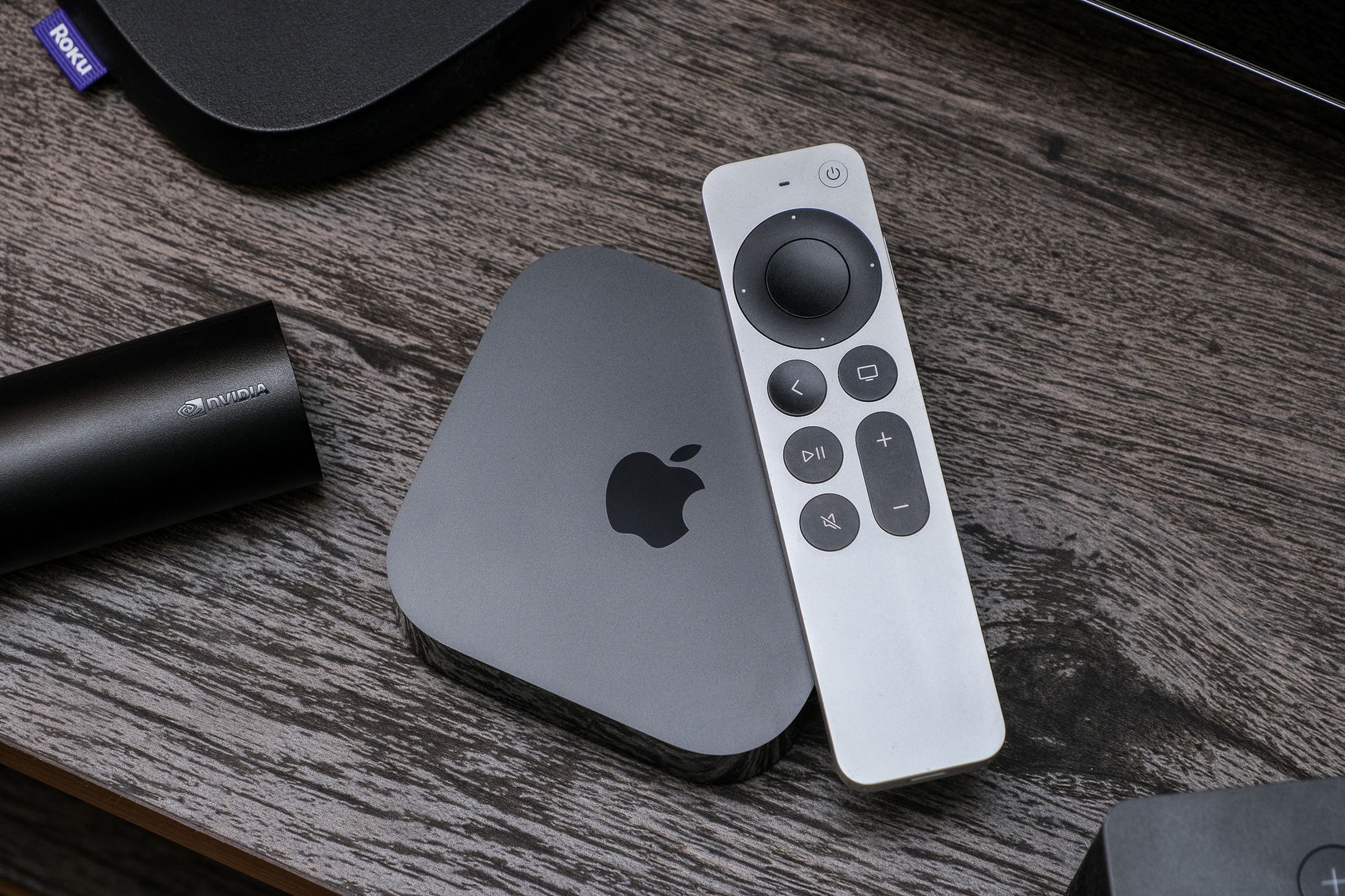 A photo of the third-gen Apple TV 4K on a TV stand.