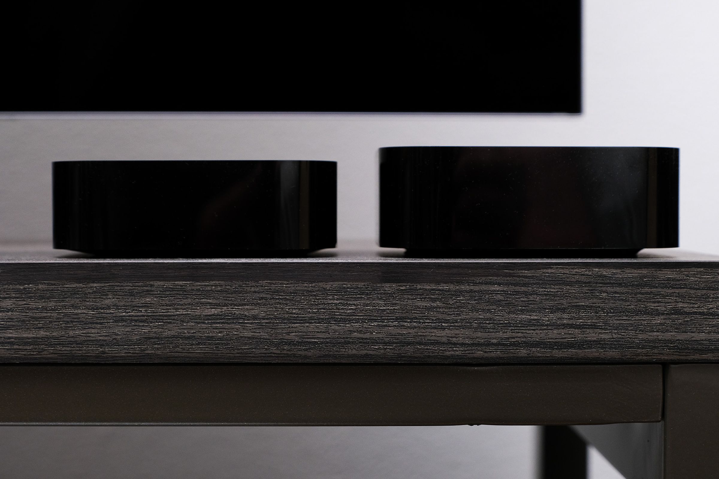 A photo comparing the height of the second-gen and third-gen Apple TV 4K.
