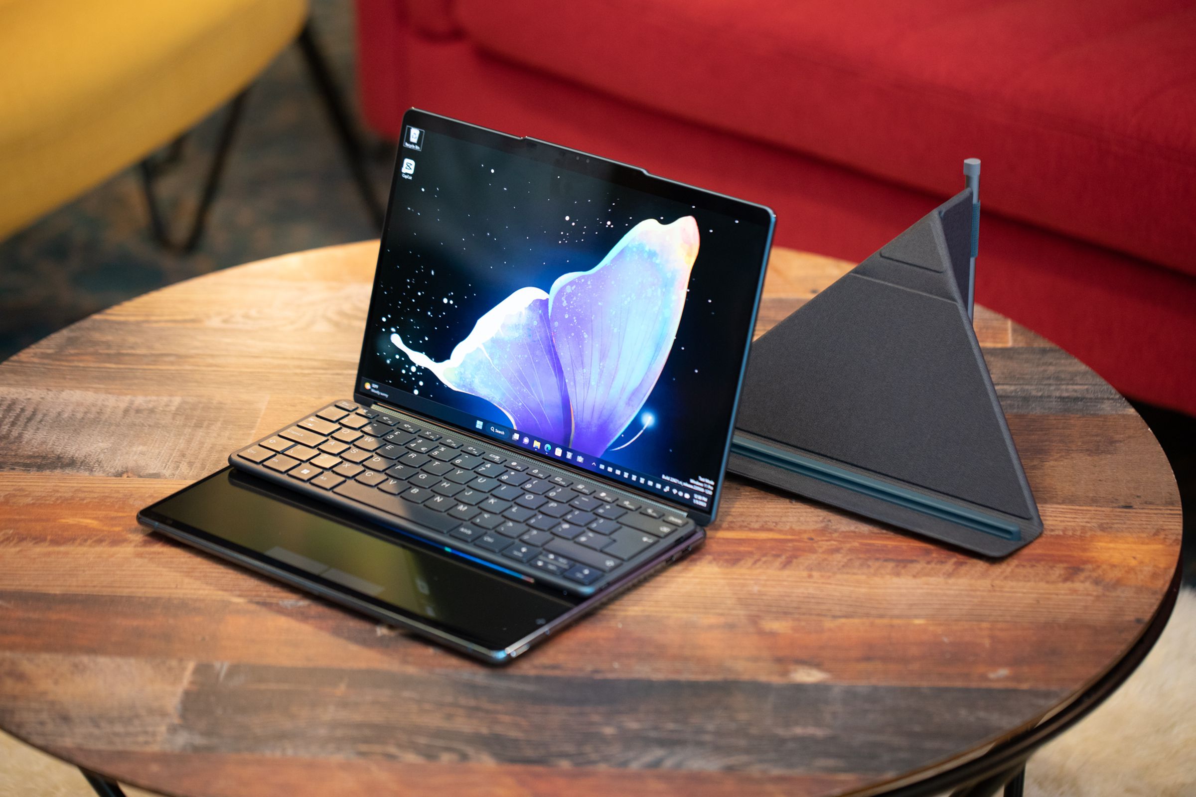 The Lenovo Yoga Book 9i folds into laptop mode with a keyboard attached.