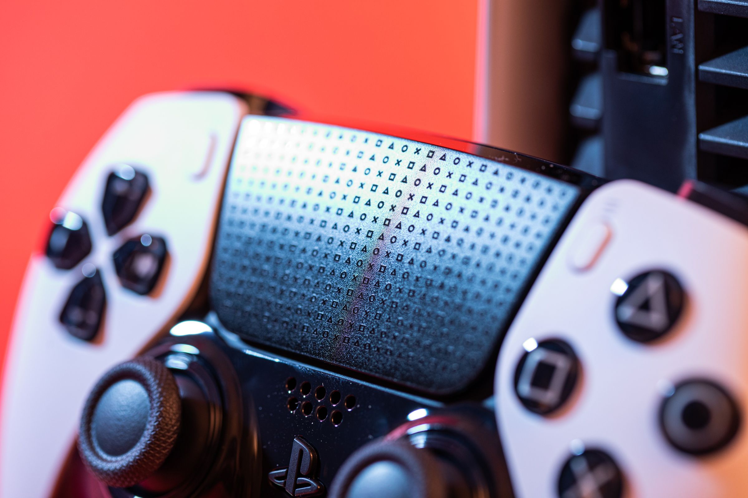 A close-up shot of the DualSense Edge controller’s touchpad which is adorned in cross, square, triangle, and circle shapes.