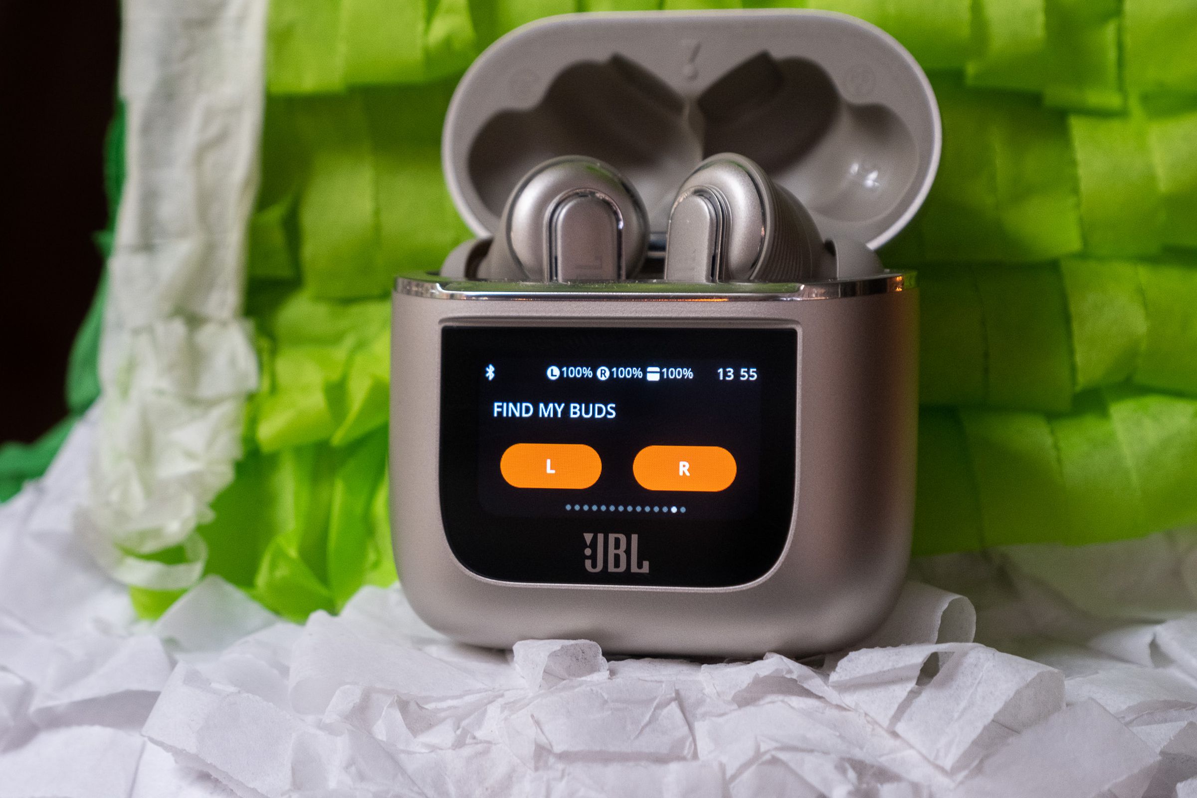 A photograph of JBL’s Tour Pro 2 earbuds and smart case with a built-in touchscreen.