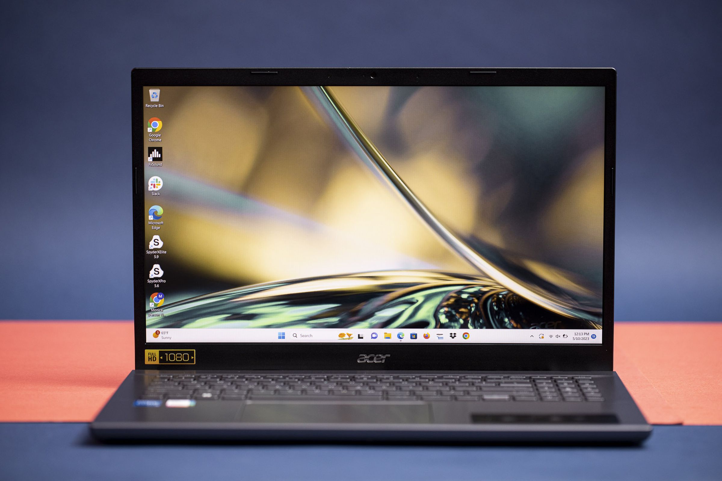 The Acer Aspire 5 displaying a green desktop background.