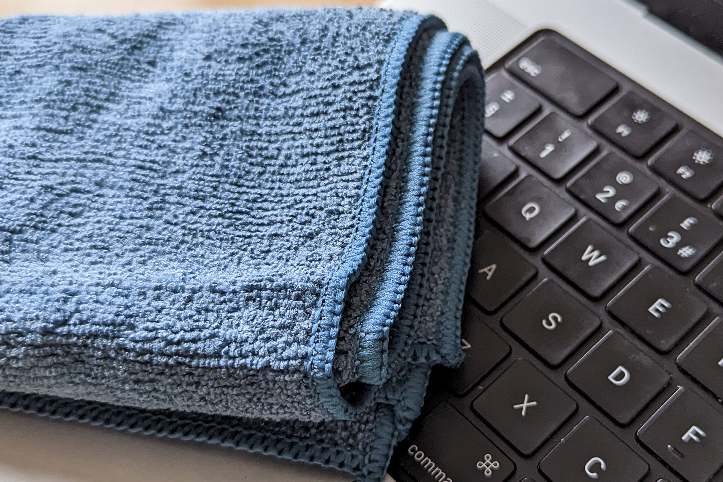 Blue microfiber cloth laying across a keyboard.