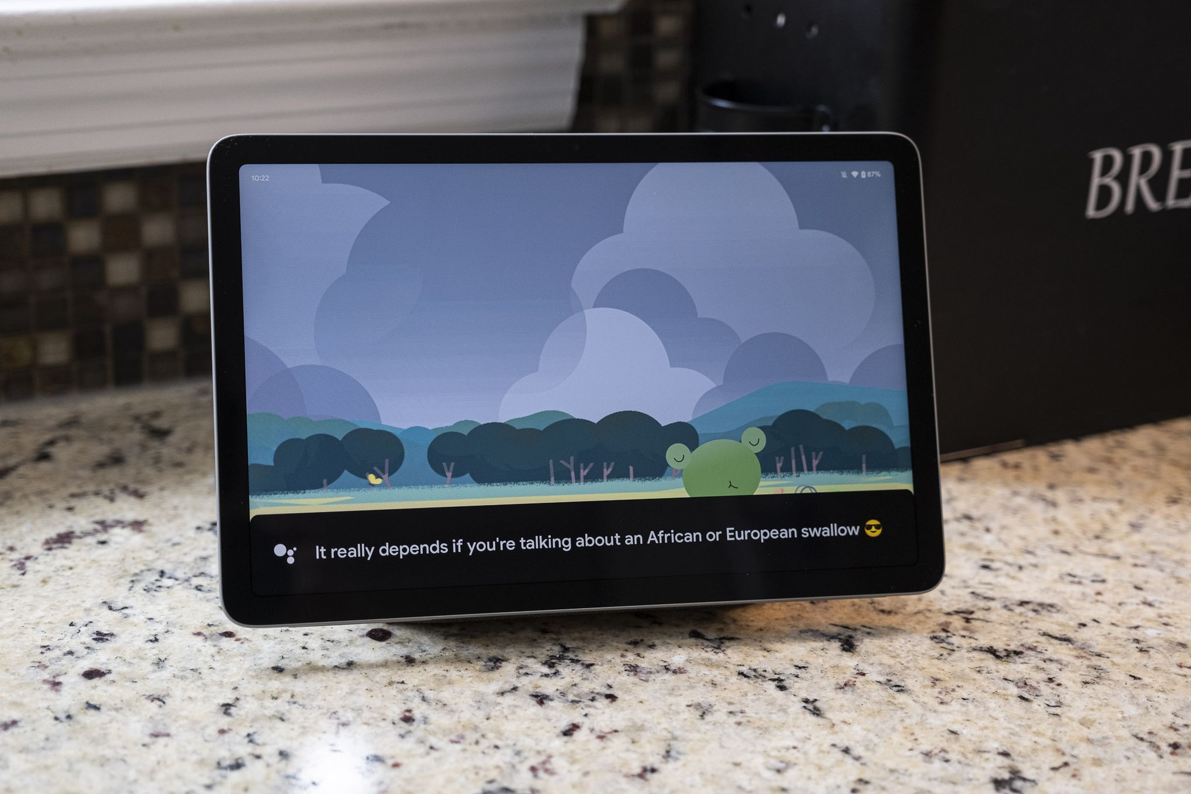 A Google Pixel Tablet on its speaker stand, sitting on a kitchen counter.