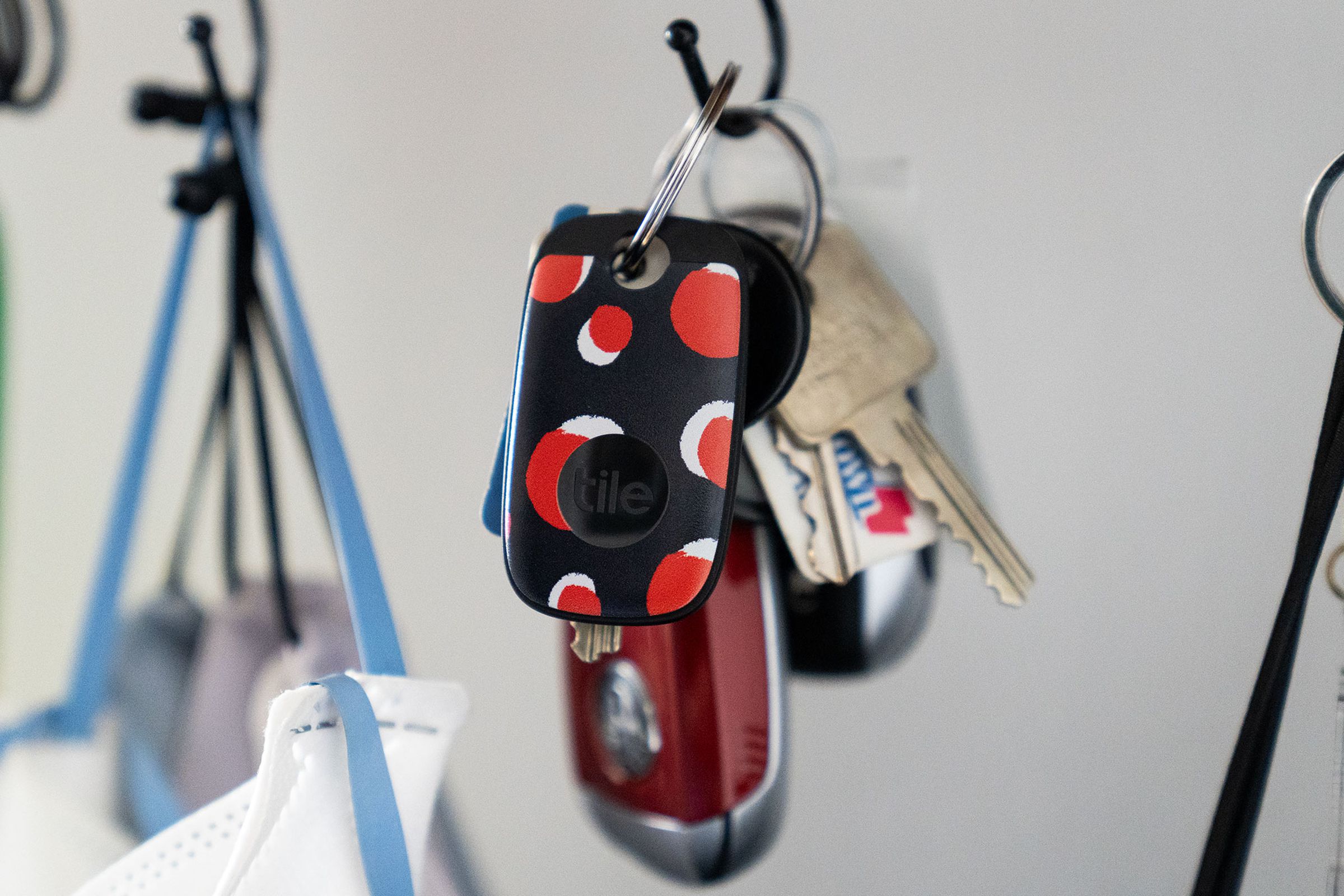 Colorful Tile Pro hanging from a key ring on a hook