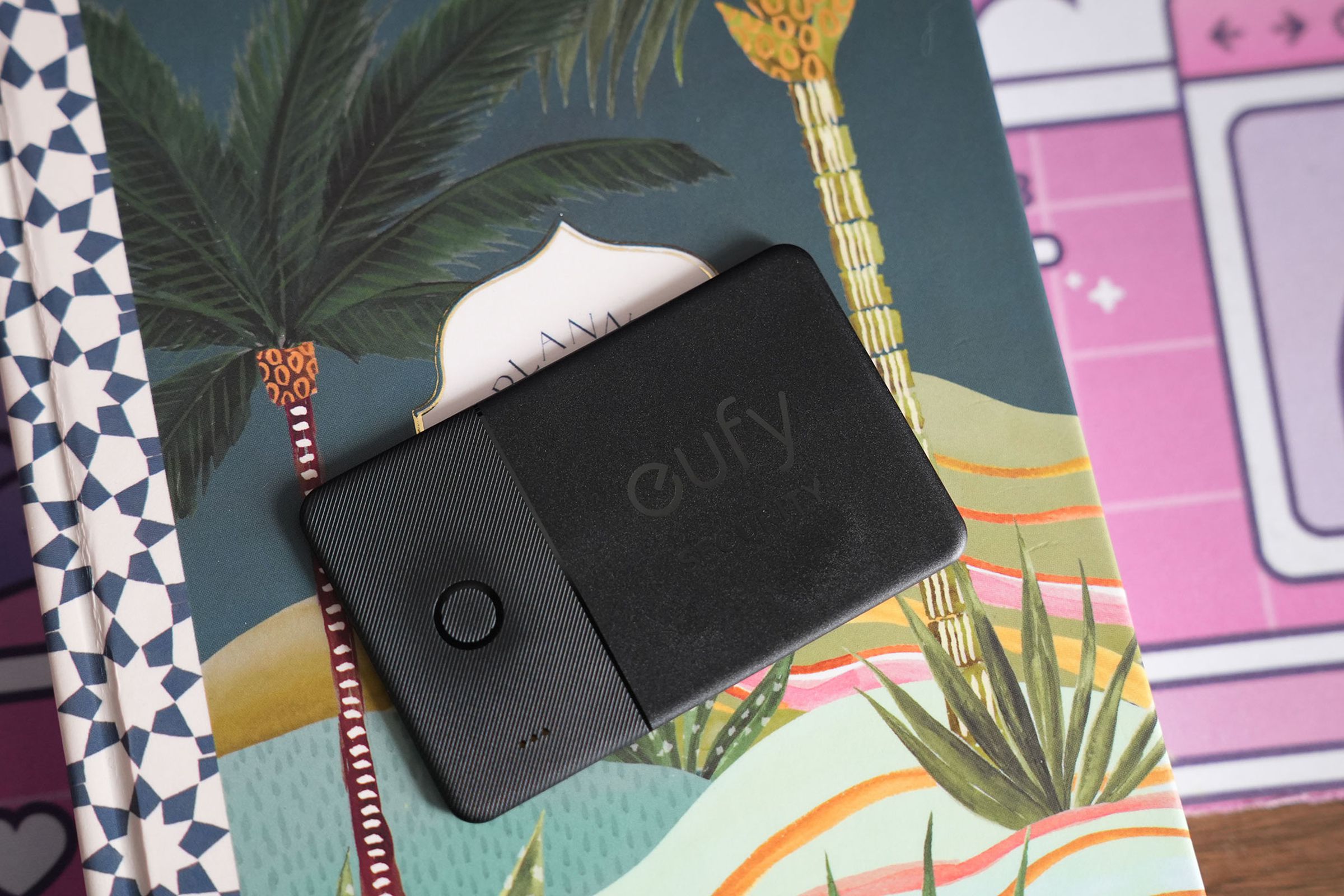 Eufy SmartTrack Card on top of a colorful notebook