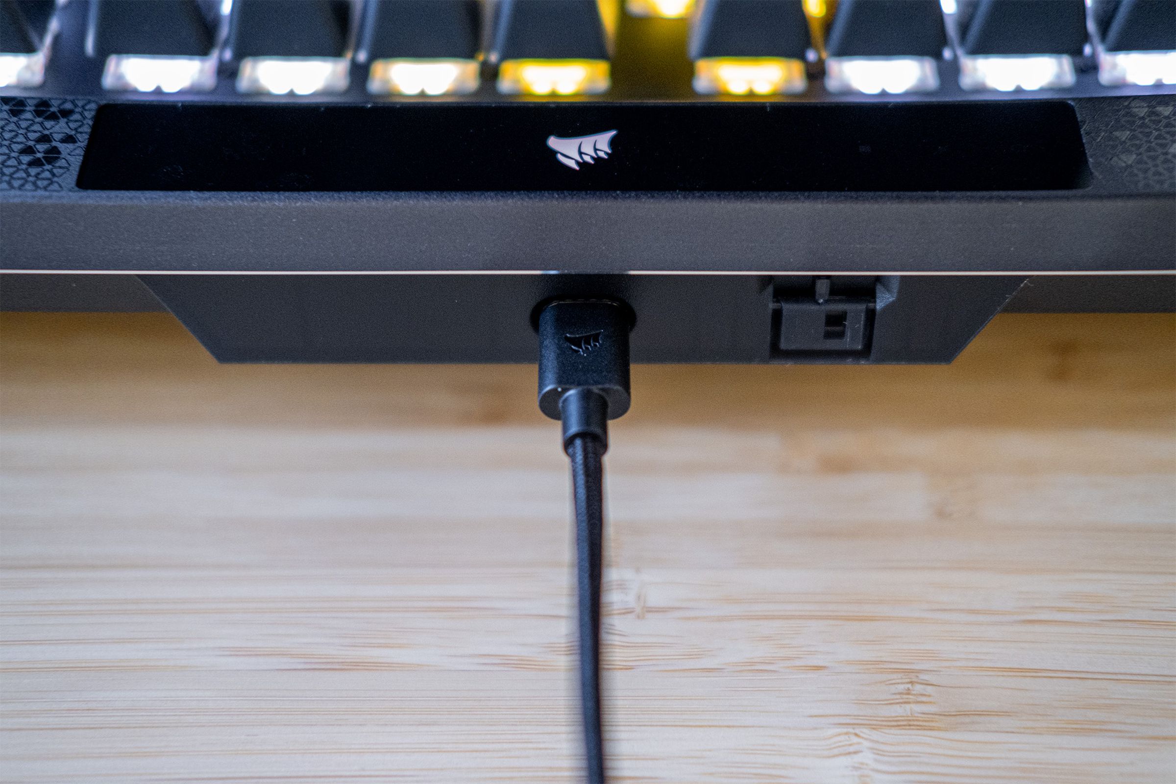 Close up of USB-C cable connected to top of keyboard.