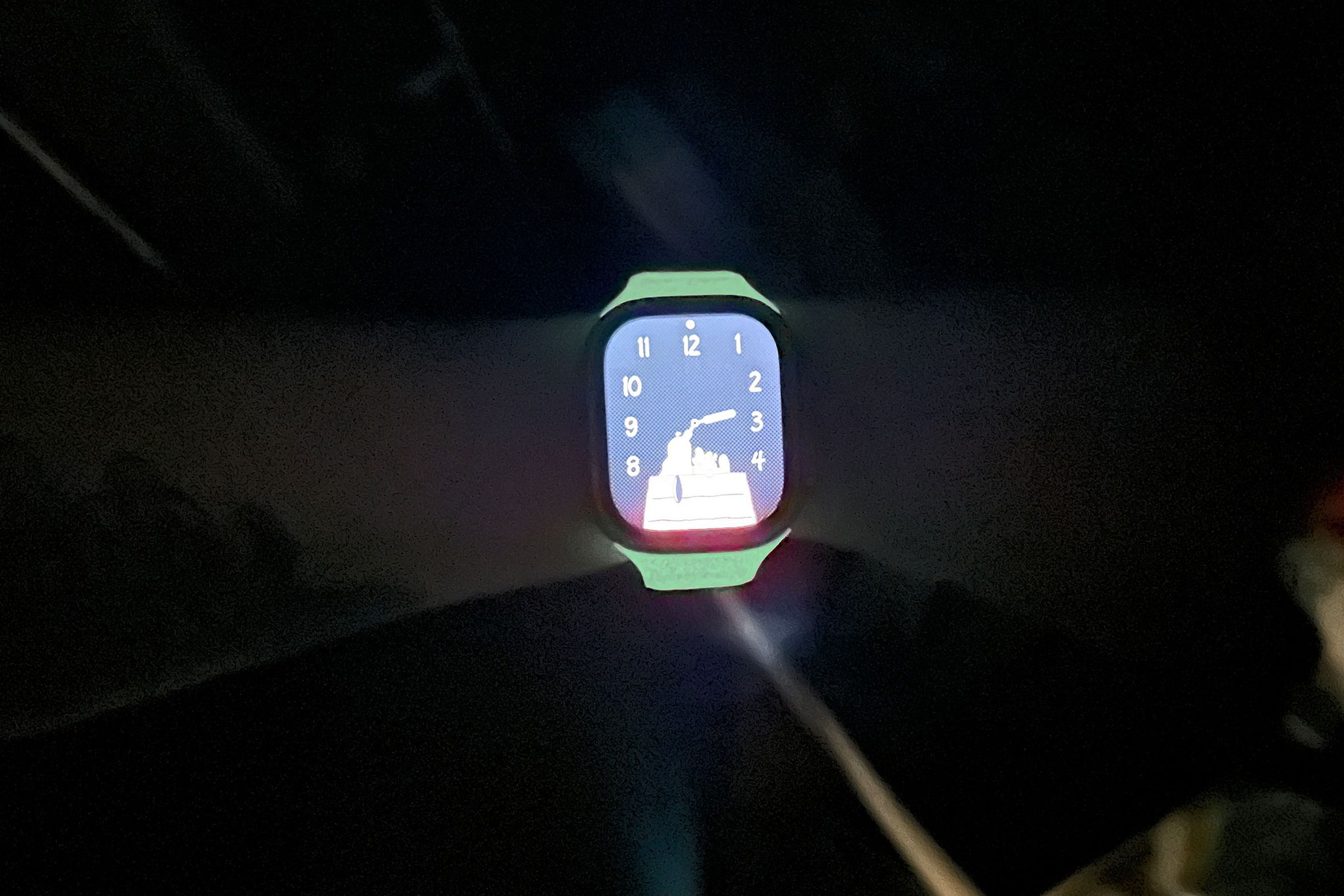 Person wearing Nomad glow in the dark strap in a dark room.