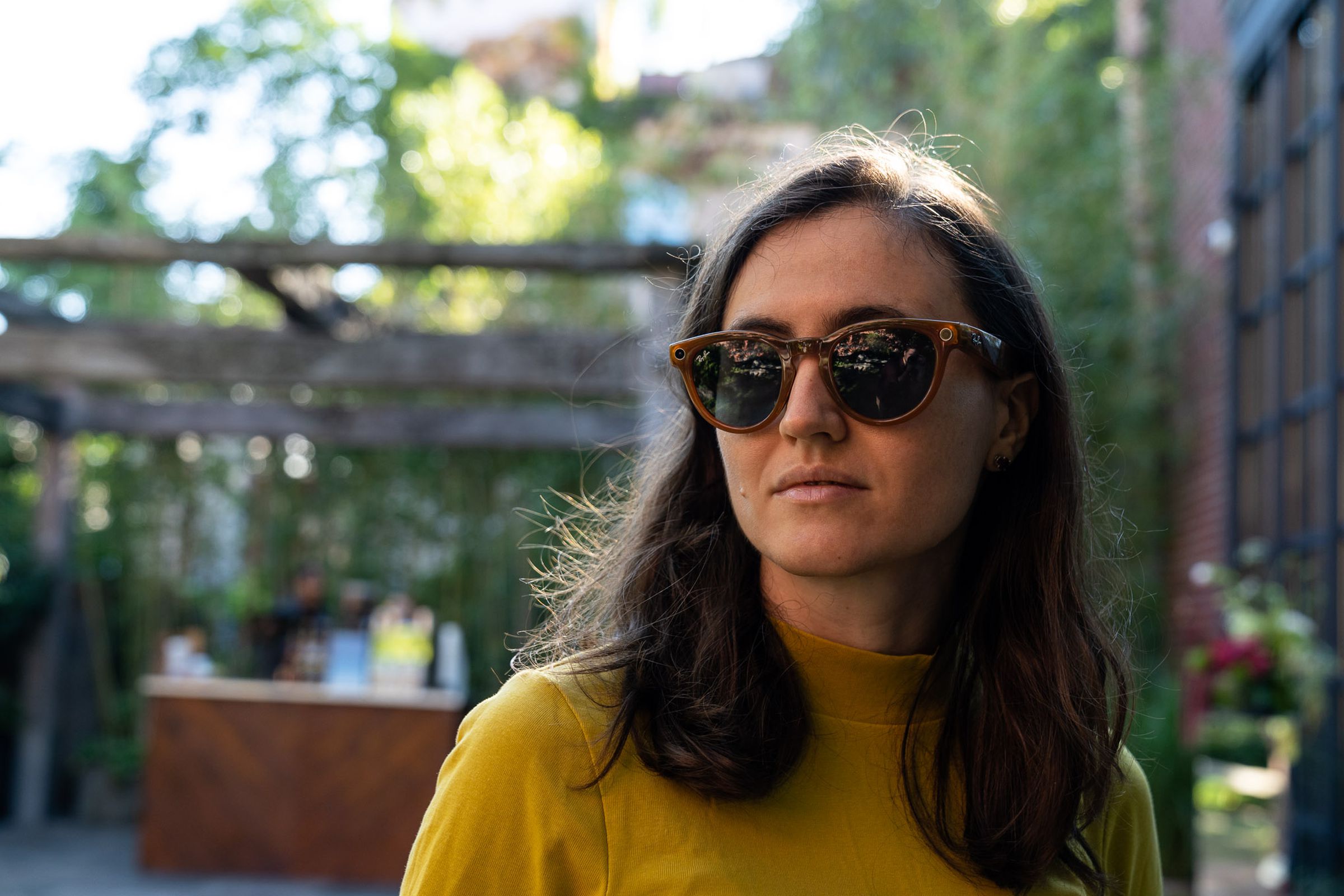Woman staring off into distance while wearing new Ray-Ban Meta Smart Glasses in the Headliner frames.