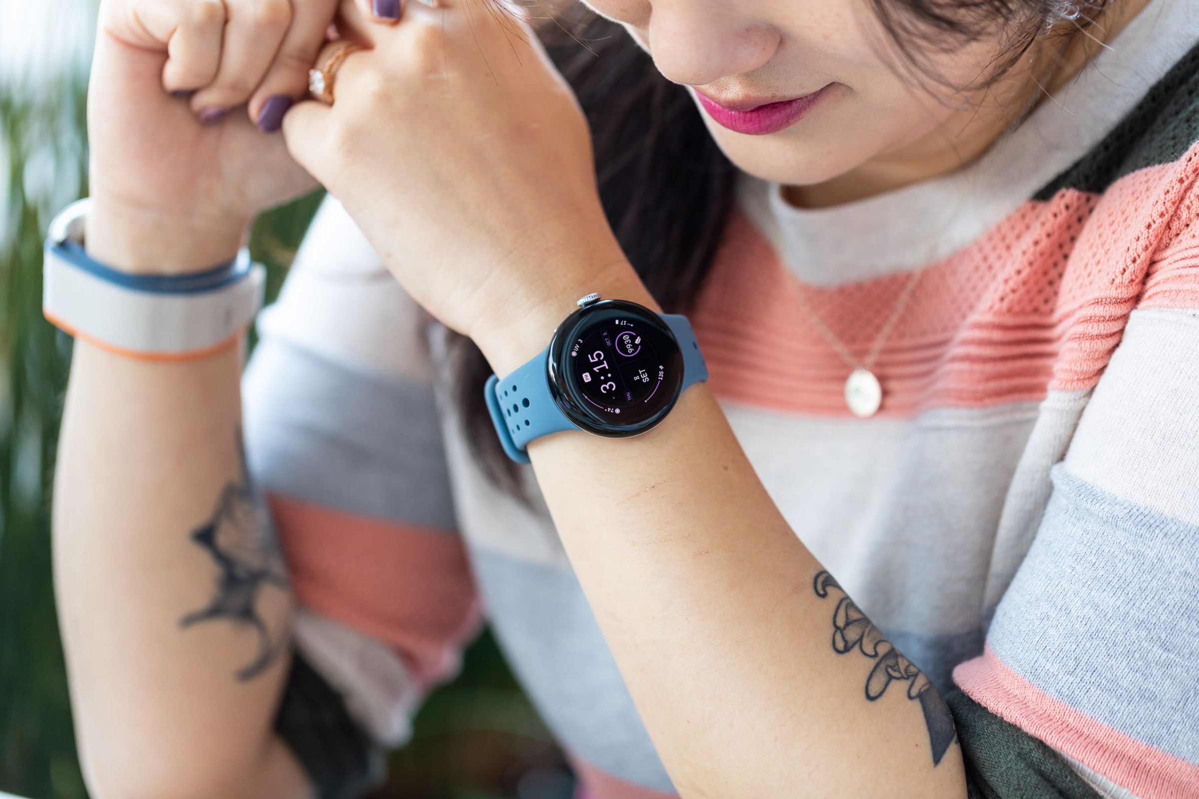 Person smiling while wearing Pixel Watch 2 on wrist