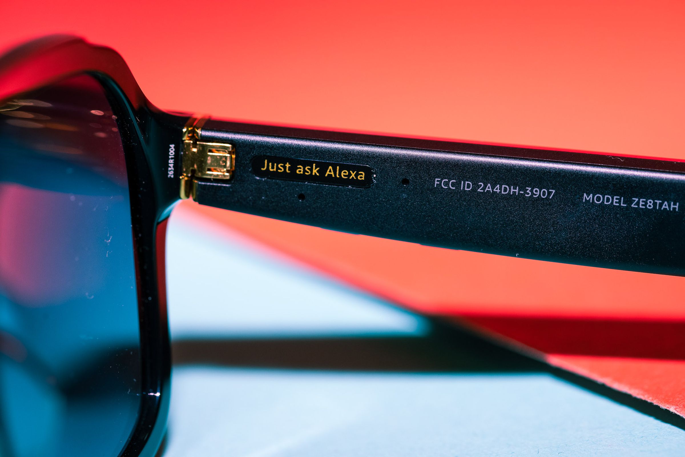 Close up of the right arm of the third-gen Amazon Echo Frames with a sticker that says Just Ask Alexa