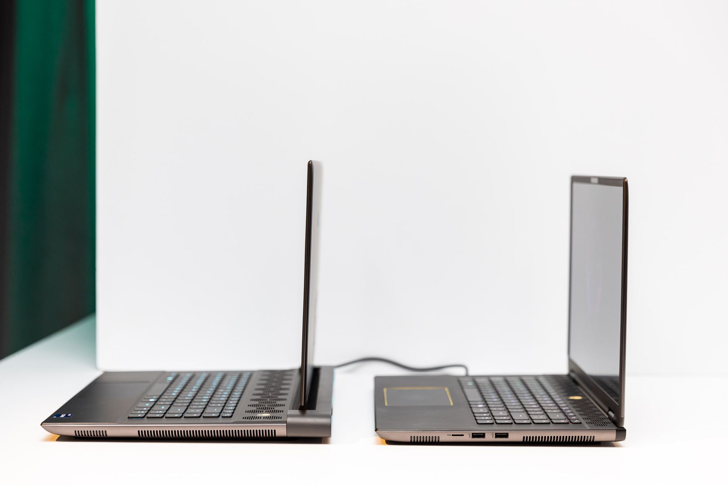 An image of two laptops side by side showcasing that one is about 1.5 inches deeper than the other.
