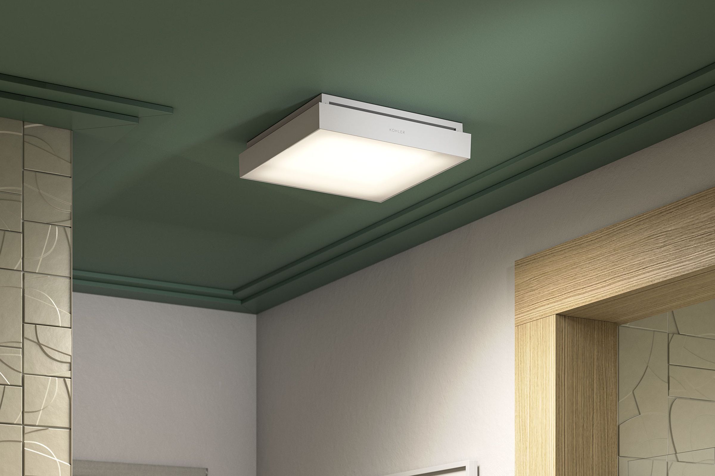 Close-up of Kohler Atmo smart bathroom fan on a green ceiling.