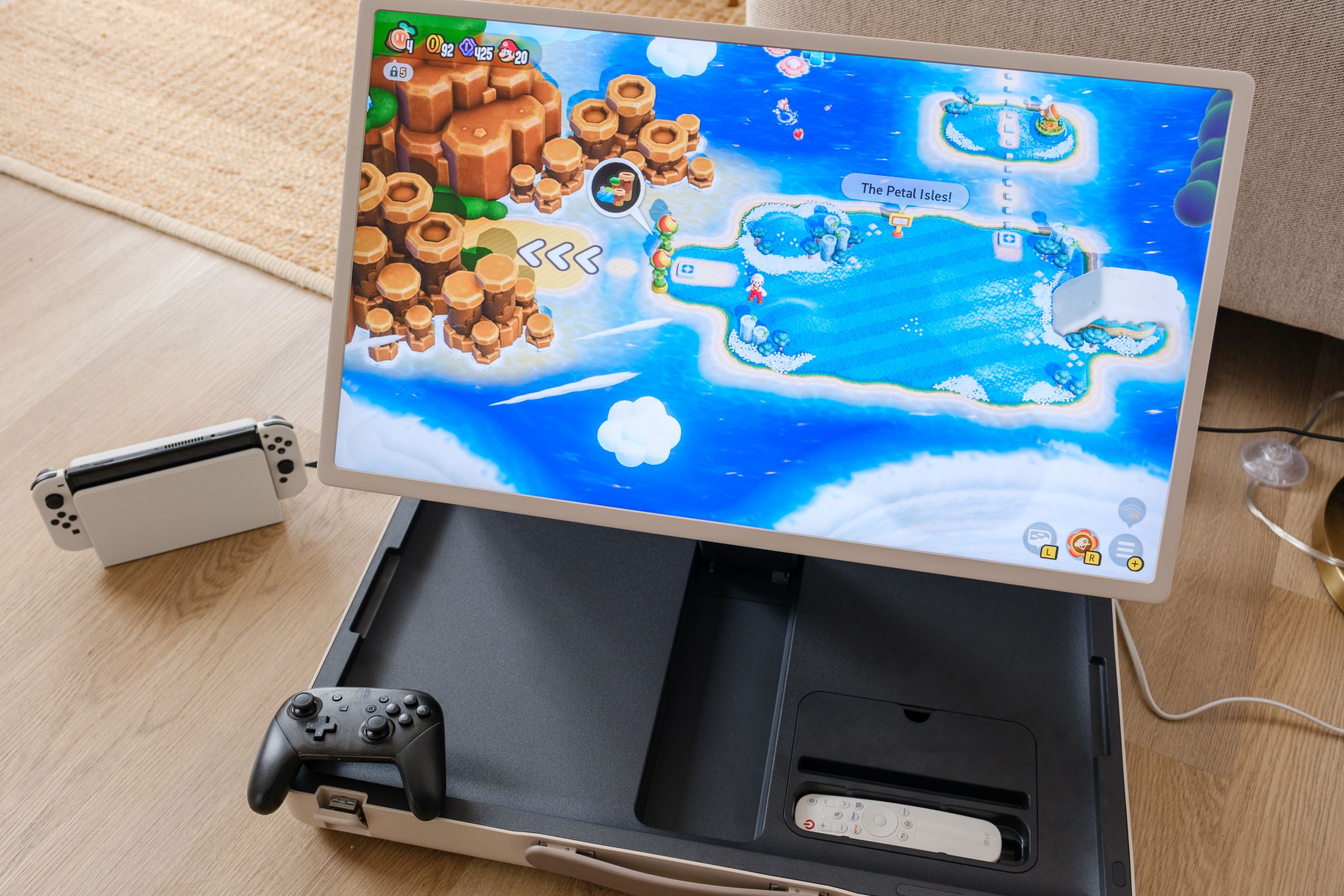 A photo of LG’s StanbyME Go briefcase TV being used alongside a Nintendo Switch OLED gaming console.