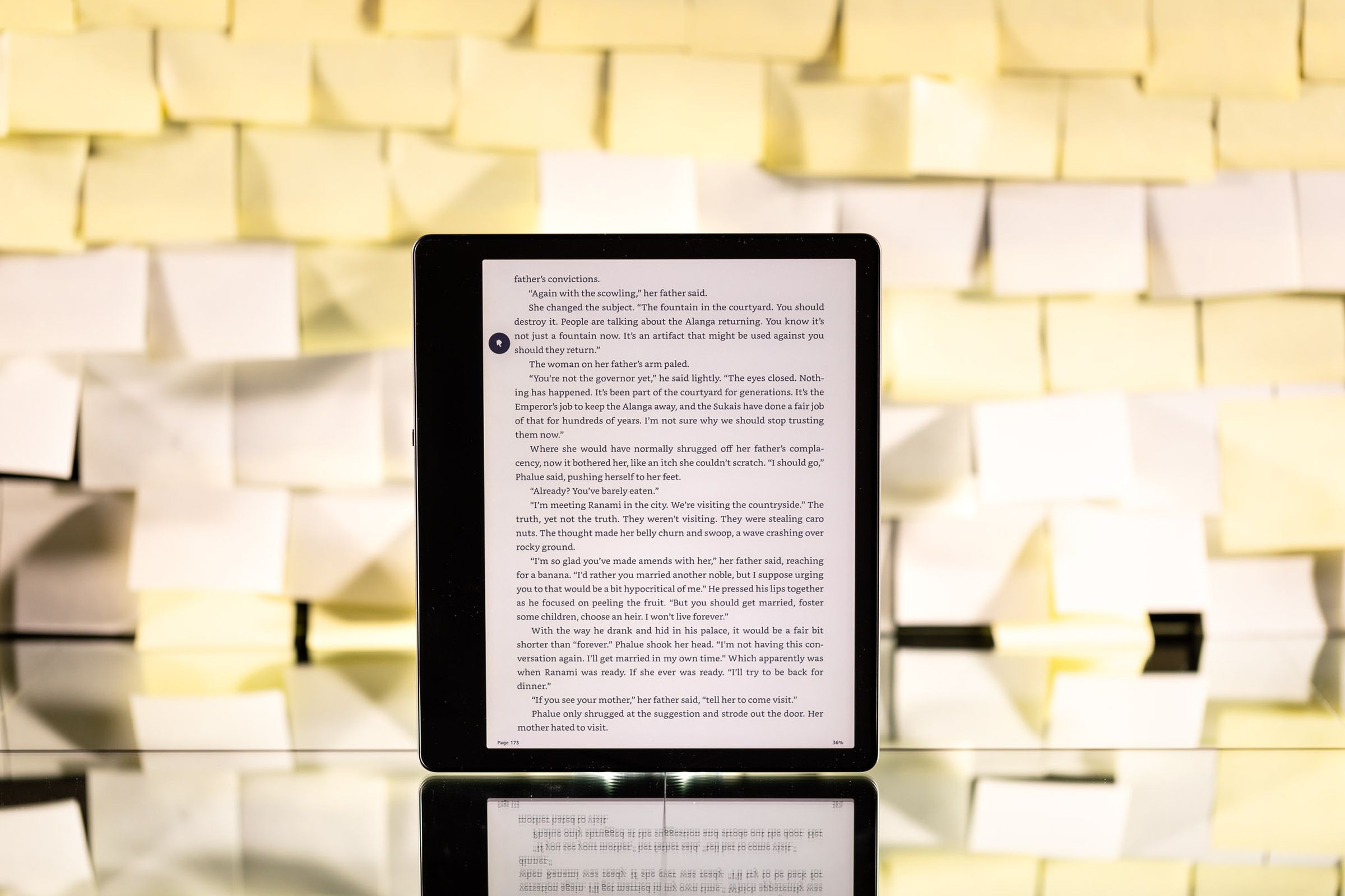The Kindle Scribe turned on against a backdrop of Post-it notes.