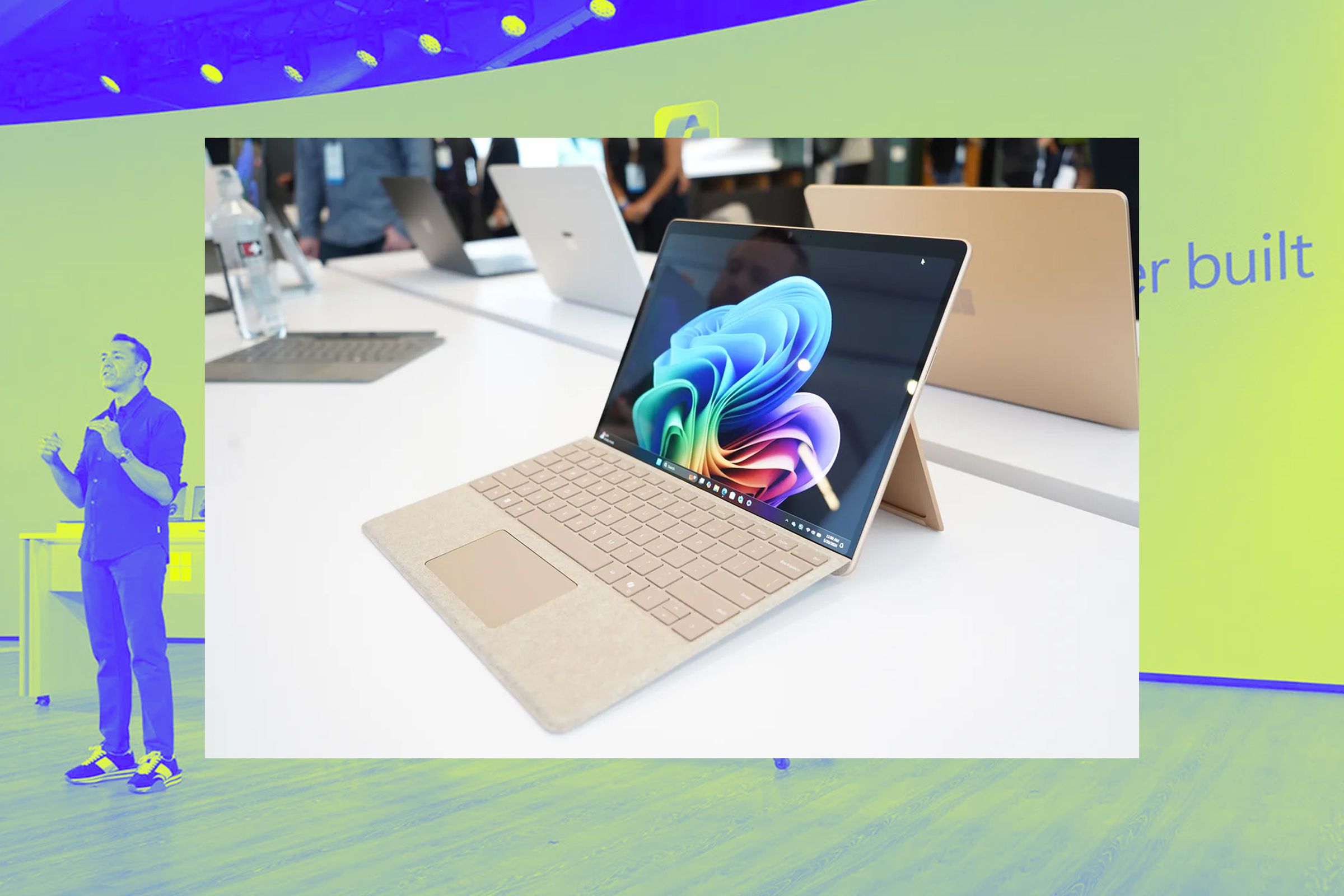 A photo of the Surface Laptop, on top of a Vergecast illustration.
