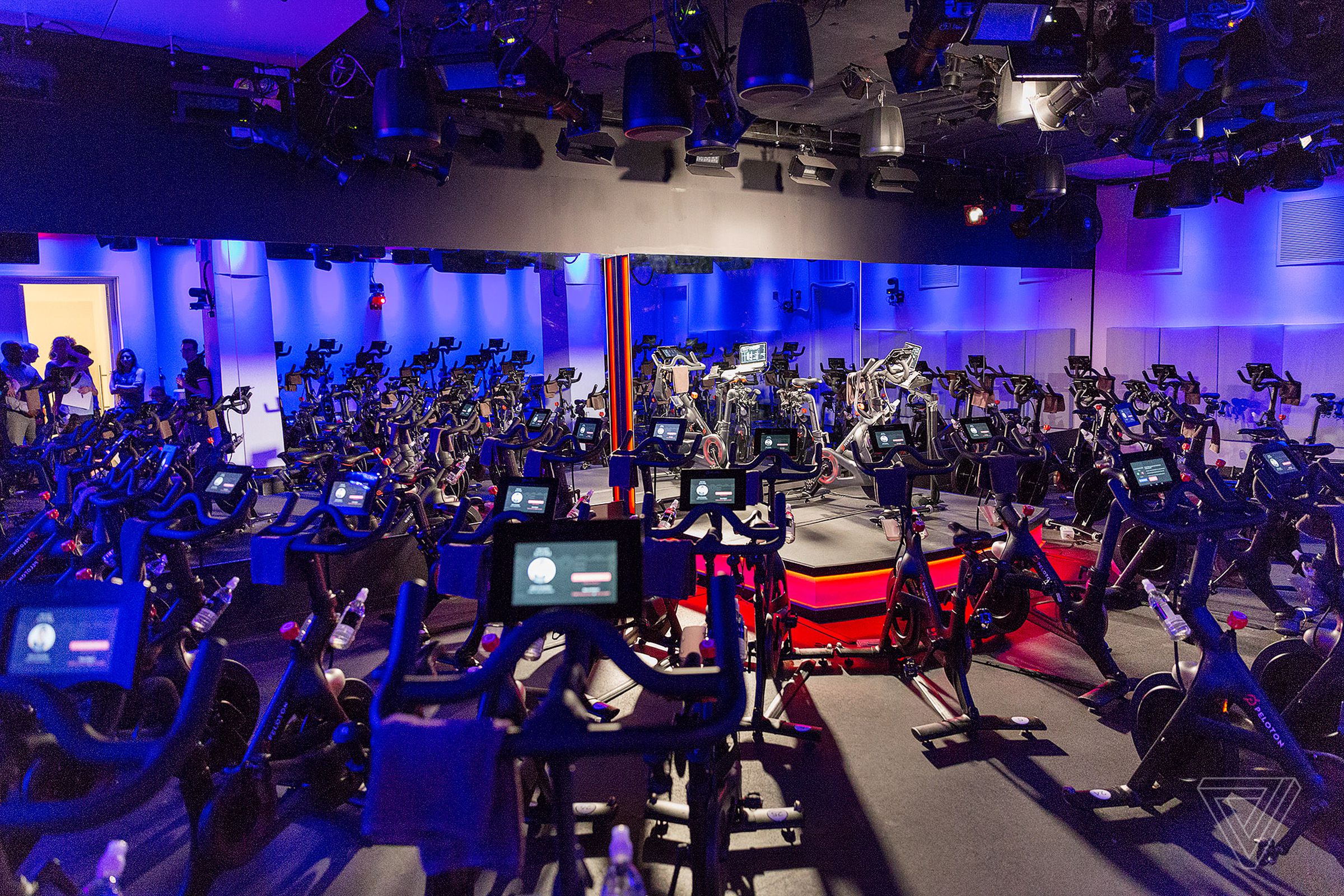 An empty Peloton studio with several of its bikes